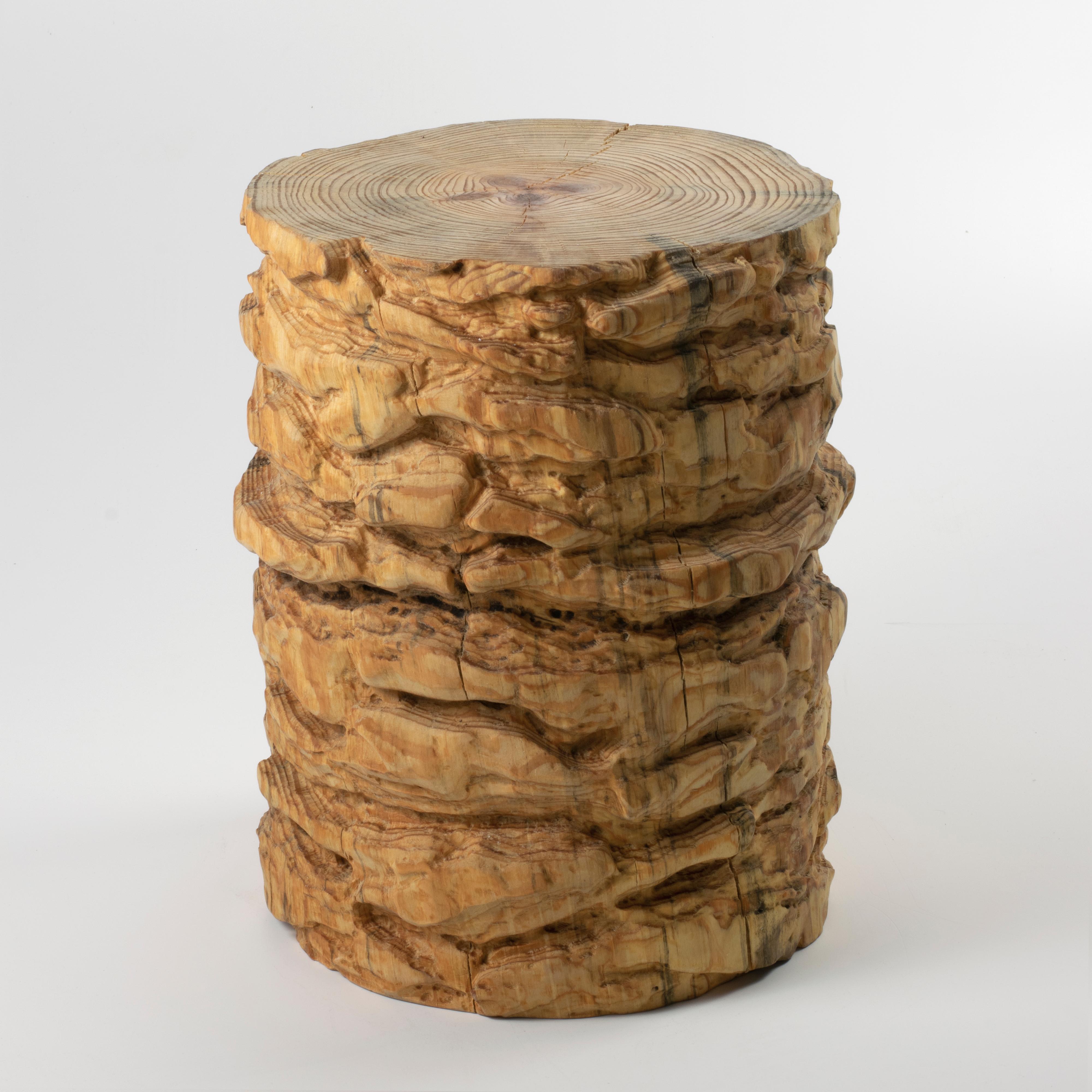 These wooden stools are digitally fabricated by artist Ezra Ardolino at Timbur LLC. 

The process consists of pine bark displacement data mapped to a cylindrical form; zero, forty-five and ninety degree rotations. Robotically machined in kiln dried