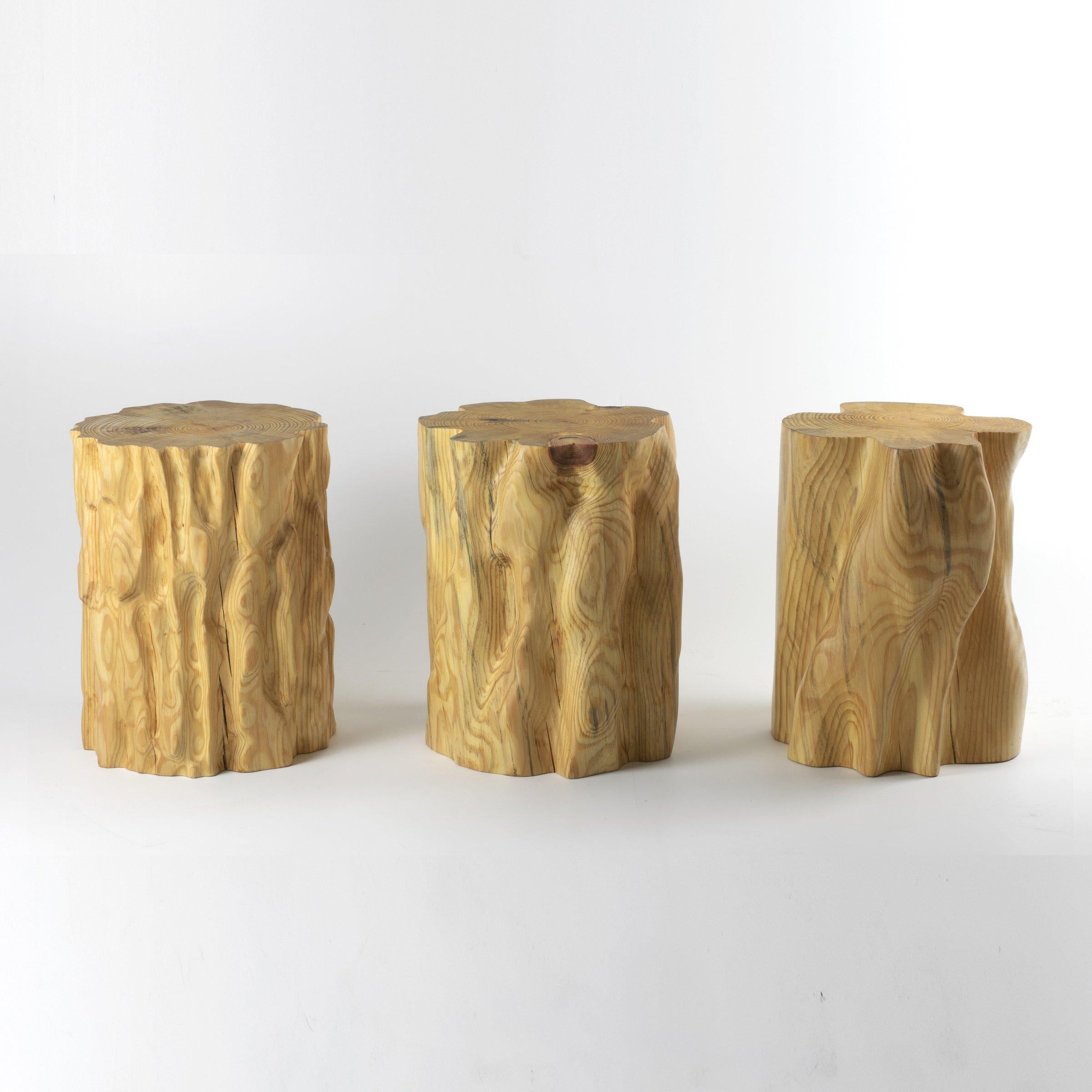 These wooden stools are digitally fabricated by artist Ezra Ardolino at Timbur LLC. 

The process consists of pine bark displacement data mapped to a cylindrical form; one, two and four times enlargement. Robotically machined in Pine timber. Oil