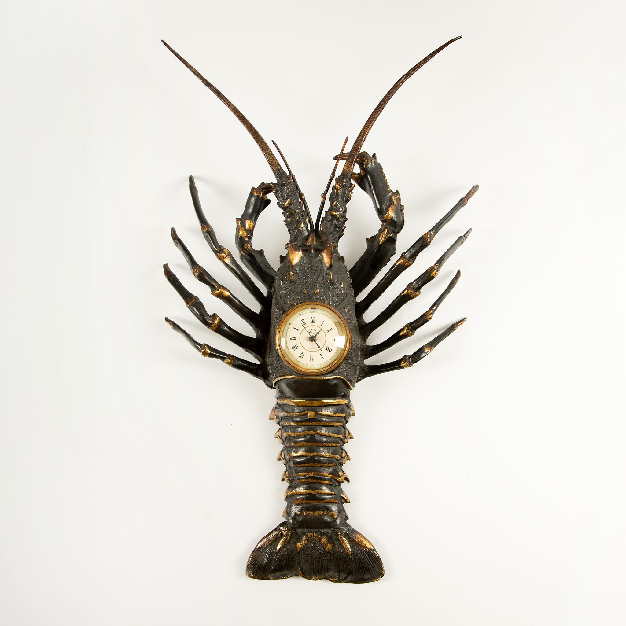 French Lobster Clock, Early 20th Century
An exceptional French bronze lobster-form clock, dating from the early 20th century. Crafted in patinated bronze with striking gilt accents, the piece features a detailed sculptural rendering of a lobster,