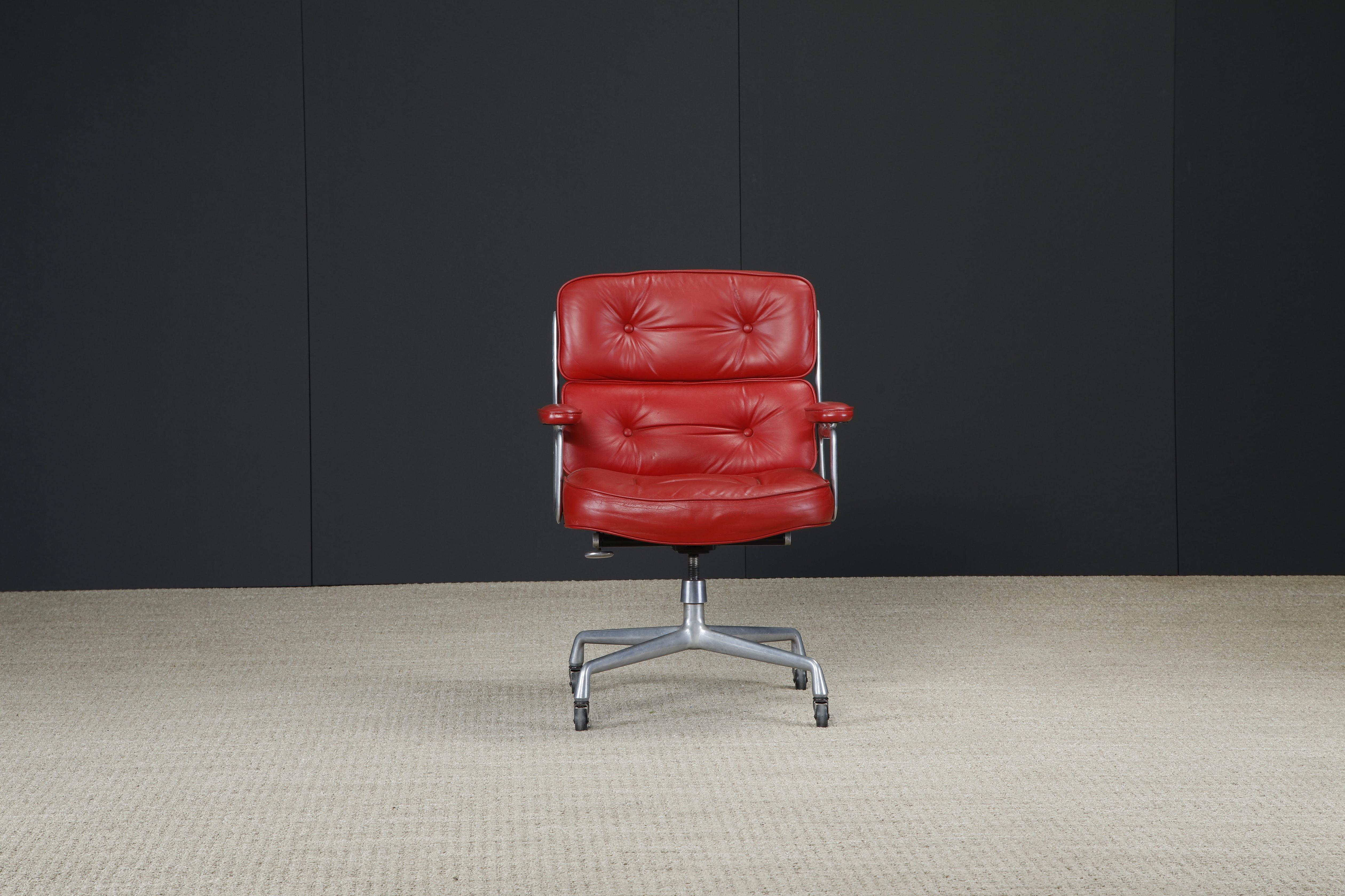 This rare color-way in beautiful red leather is the Time Life Executive Chair (Model ES-104) by Charles and Ray Eames for Herman Miller, originally designed in 1960 for the Time Life building hence the chair's name. 

Signed and dated on a Herman