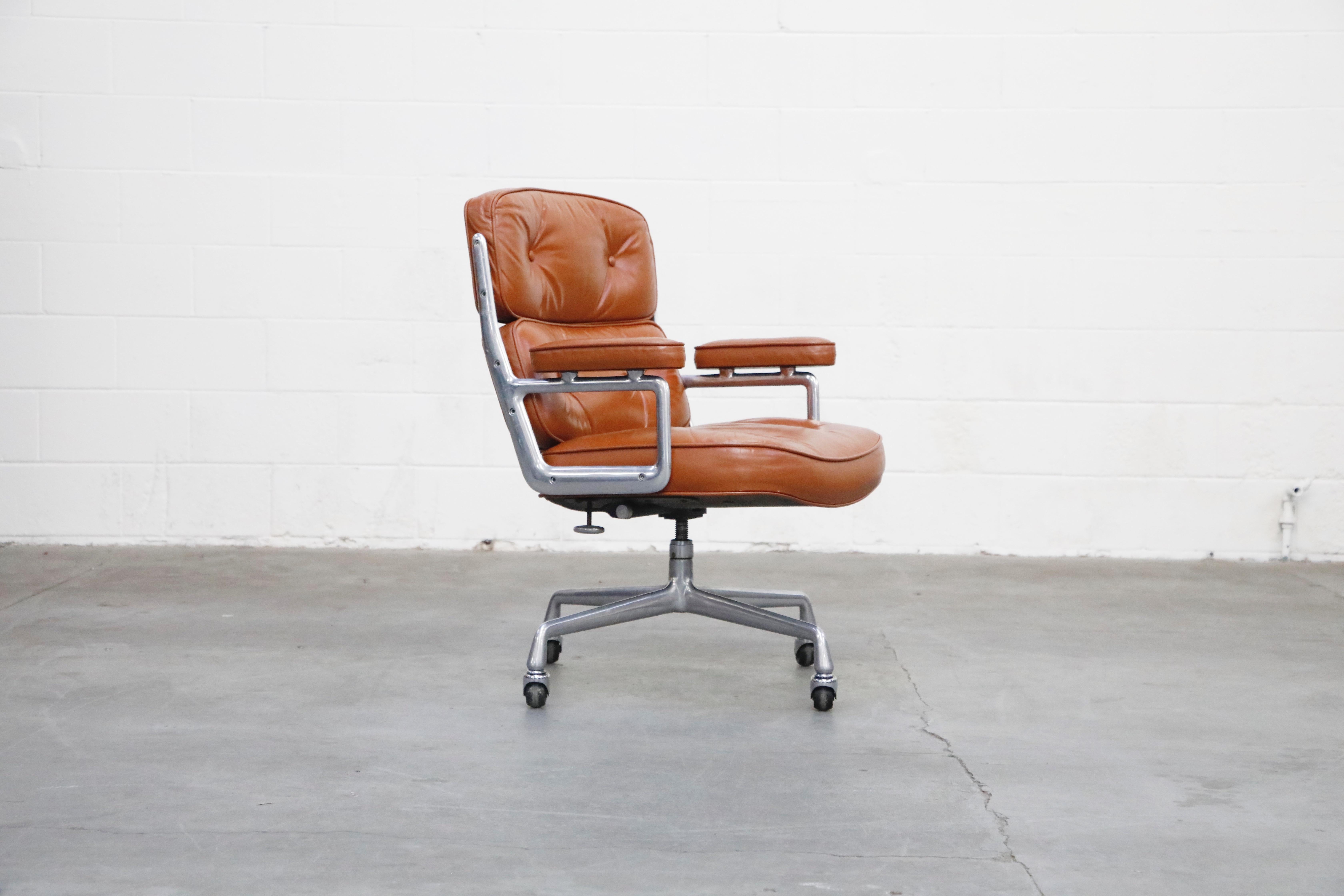 These incredible cognac brown leather 'Time Life' executive desk chairs were designed by Charles and Ray Eames in 1959 and manufactured by Herman Miller. These comfortable and ergonomic executive chairs feature their original cognac brown colored