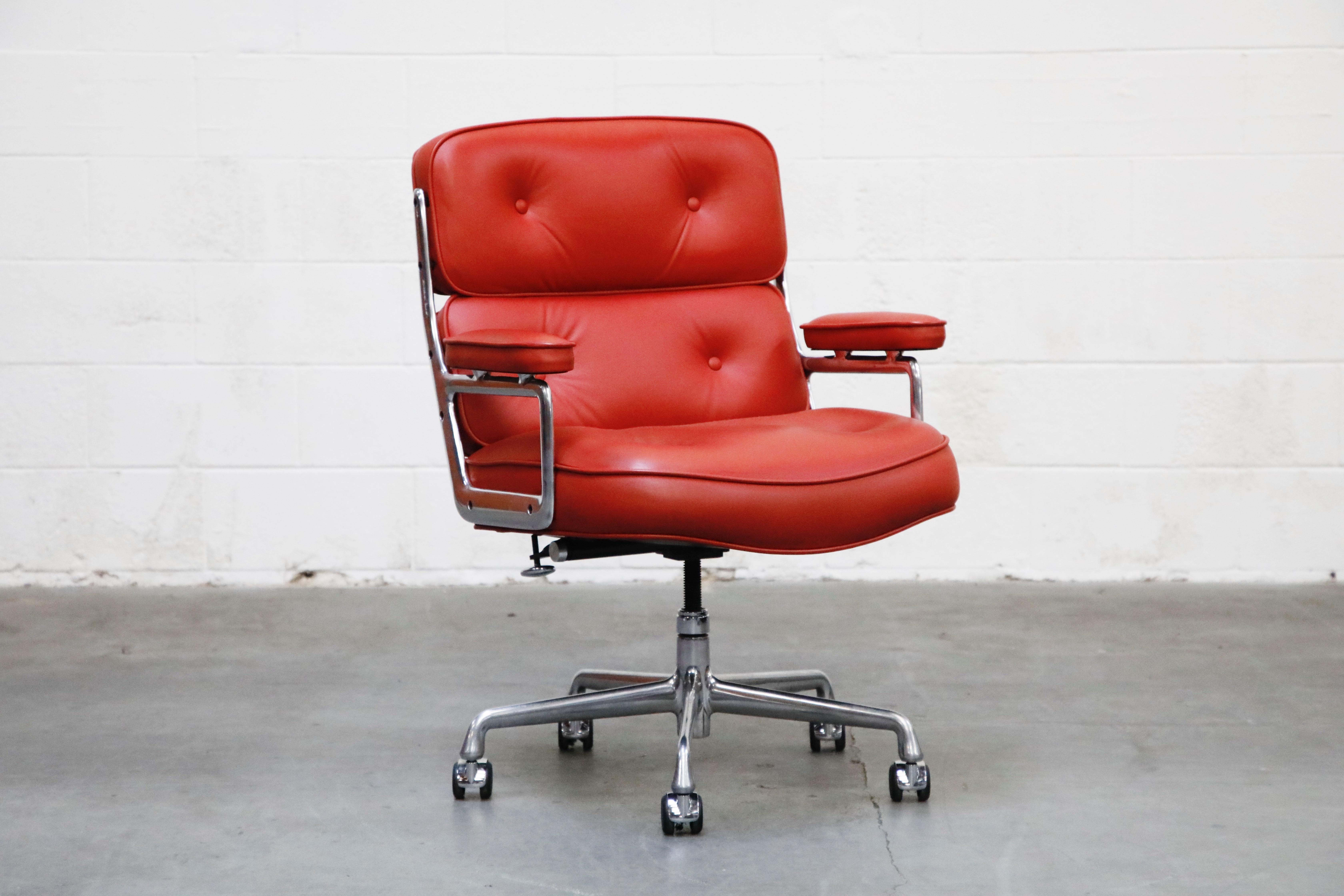 This incredible red leather 'Time Life' executive desk chair was designed by Charles and Ray Eames in 1959 and manufactured by Herman Miller. This comfortable and ergonomic executive chair features its original red leather over aluminum frame with