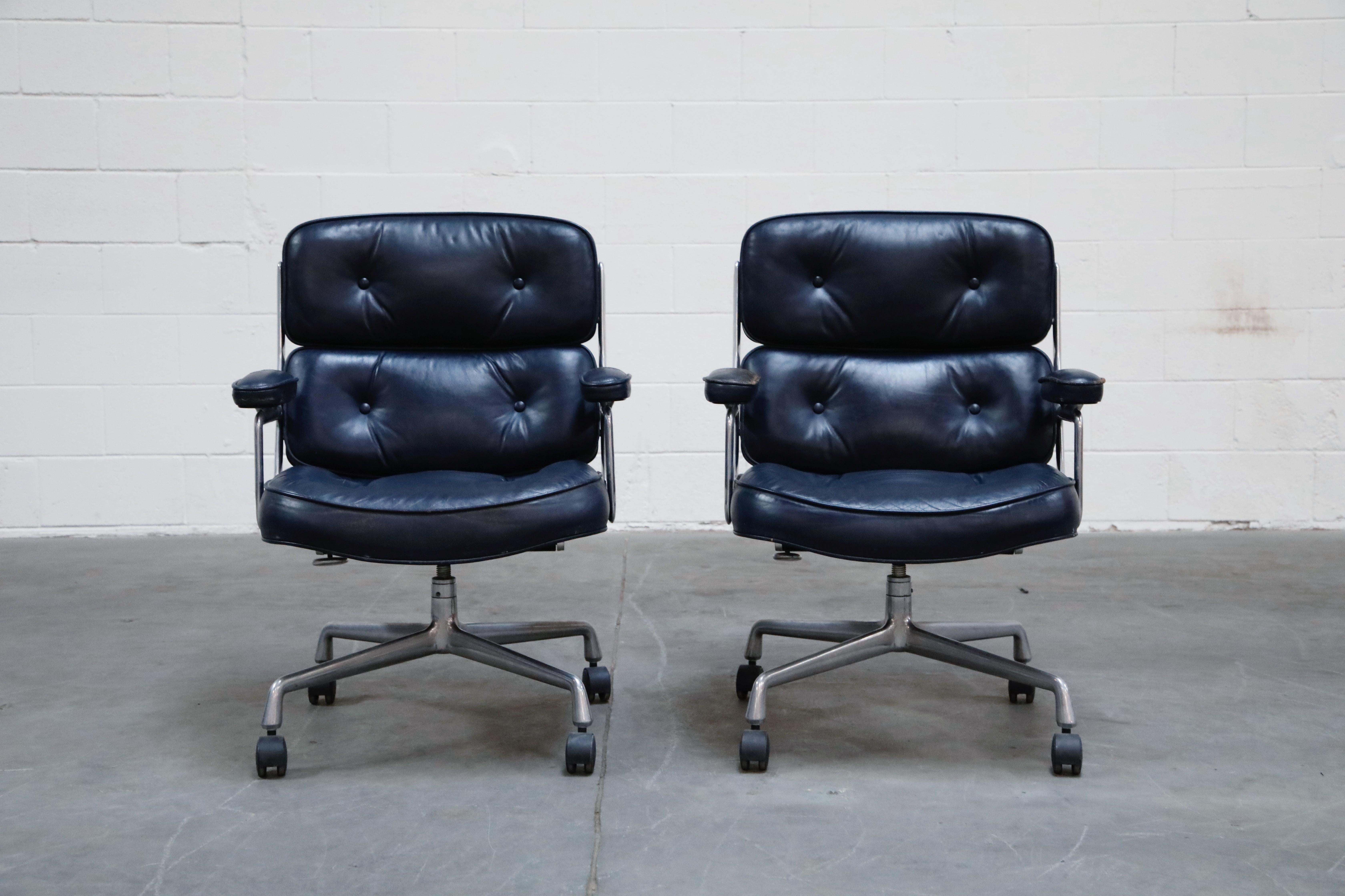 This wonderful pair of very rare color-way blue leather 'Time Life' executive desk chairs was designed by Charles and Ray Eames in 1959 and manufactured by Herman Miller. This set features its original blue colored leather that is attractively
