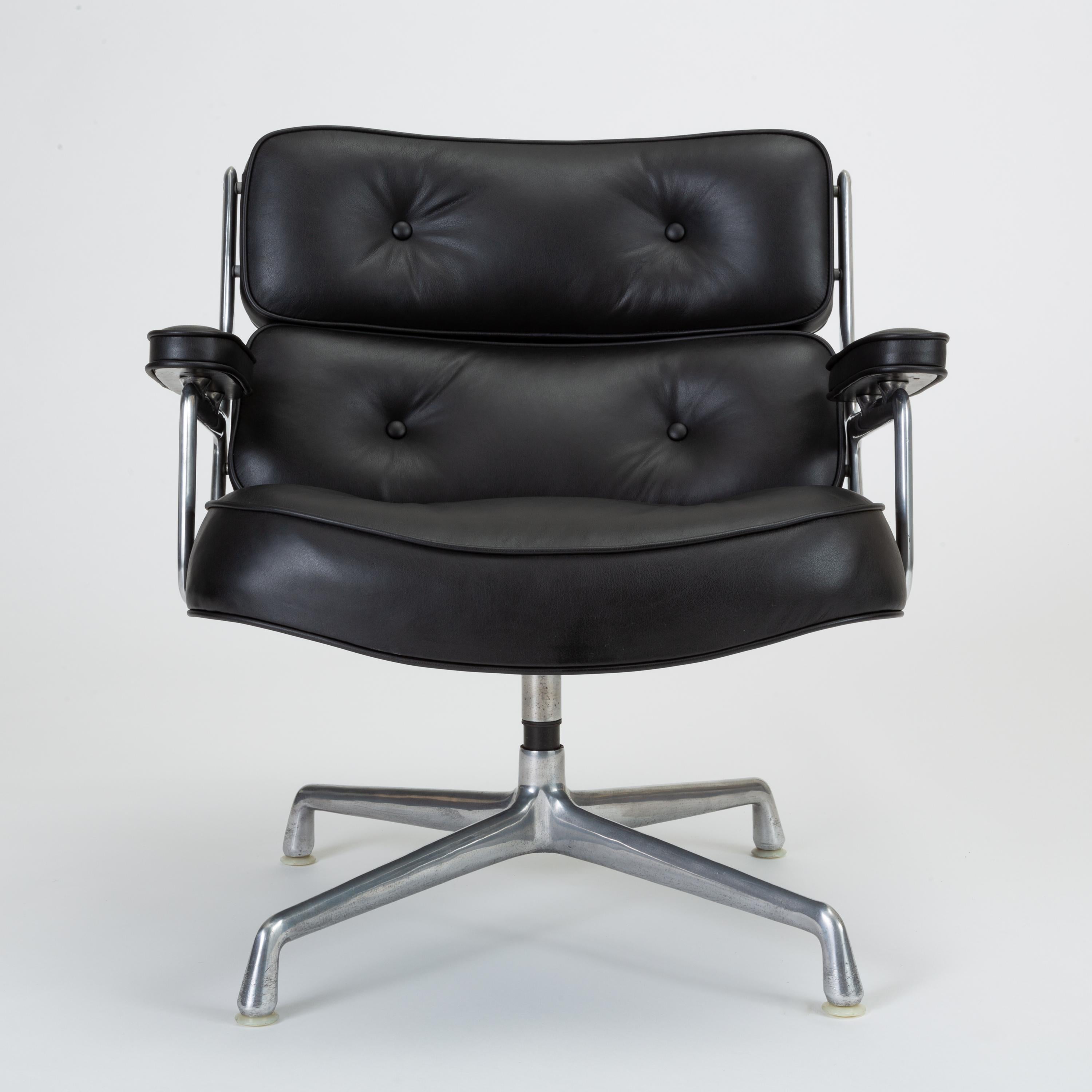 Designed in 1960 by Charles and Ray Eames for the Time Life Building in Manhattan, these chairs feature a polished aluminum frame and sumptuous tufted cushions in the original black leather. The chair sits on four plastic glides, but wheels are