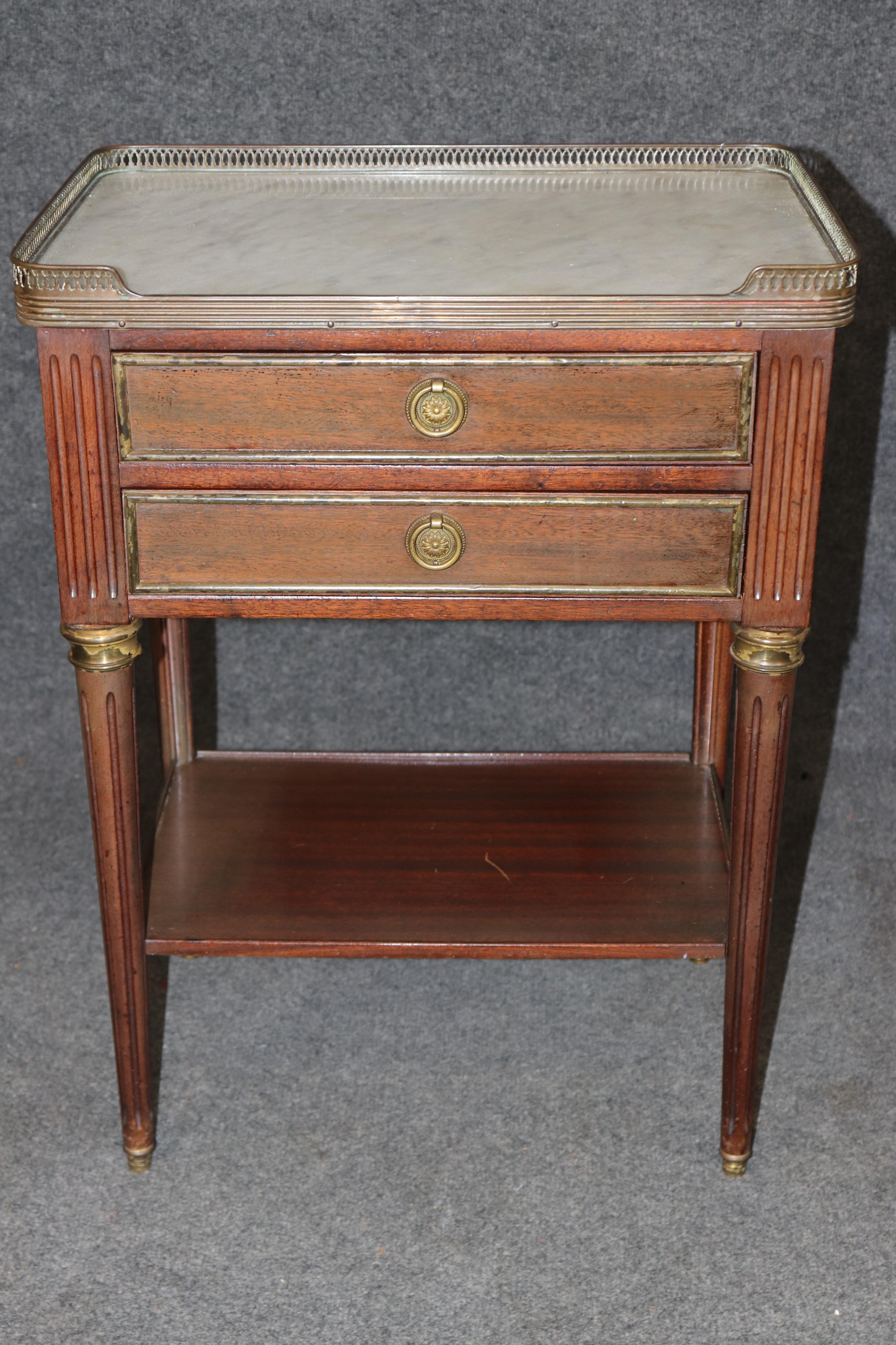 Questo elegante comodino in noce antico mette in mostra la raffinata maestria artigianale e il fascino senza tempo del design francese del XIX secolo. Caratterizzato da una splendida finitura in noce invecchiato con distorsioni naturali, questo