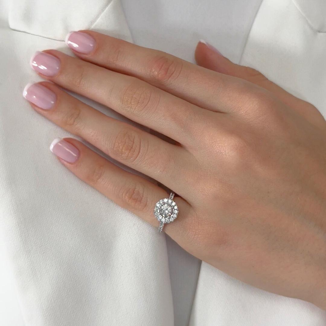 Timeless 1.03ct Diamonds Halo Ring in 18k White Gold - IGI Certified

Crafted in luxurious 18K white gold, this exquisite halo ring features a brilliant 0.50 ct round-cut diamond as its dazzling centerpiece. Surrounding it, 30 shimmering round