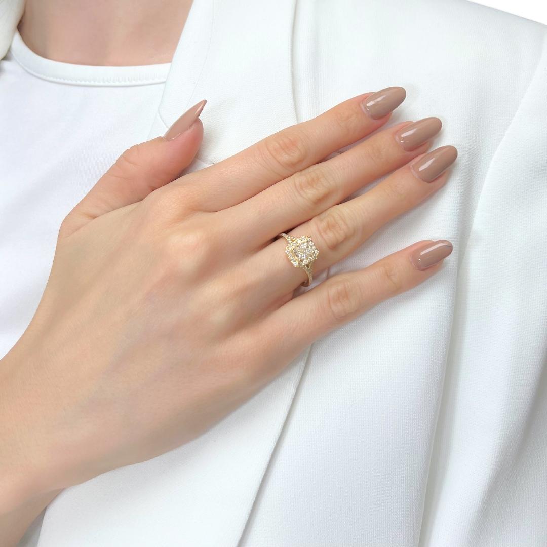 Timeless 1.10ct Diamonds Halo Ring in 18k Yellow Gold - IGI Certified

This elegant 18K yellow gold halo ring features a striking 0.75ct cut-cornered rectangular diamond at its centerpiece. Accentuating its brilliance, 30 round diamonds with 0.35ct