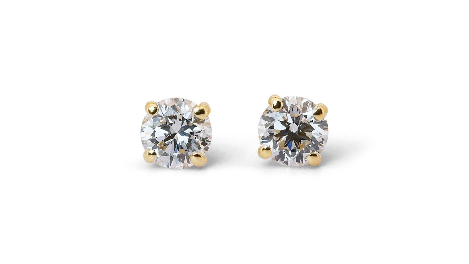 Timeless 1.20ct Triple Excellent Ideal Cut Diamonds Stud Earrings in 18k Yellow Gold - GIA Certified

Embrace elegance with these 18k yellow gold stud earrings featuring two dazzling round diamonds, totaling 1.20-carat. It showcases a triple
