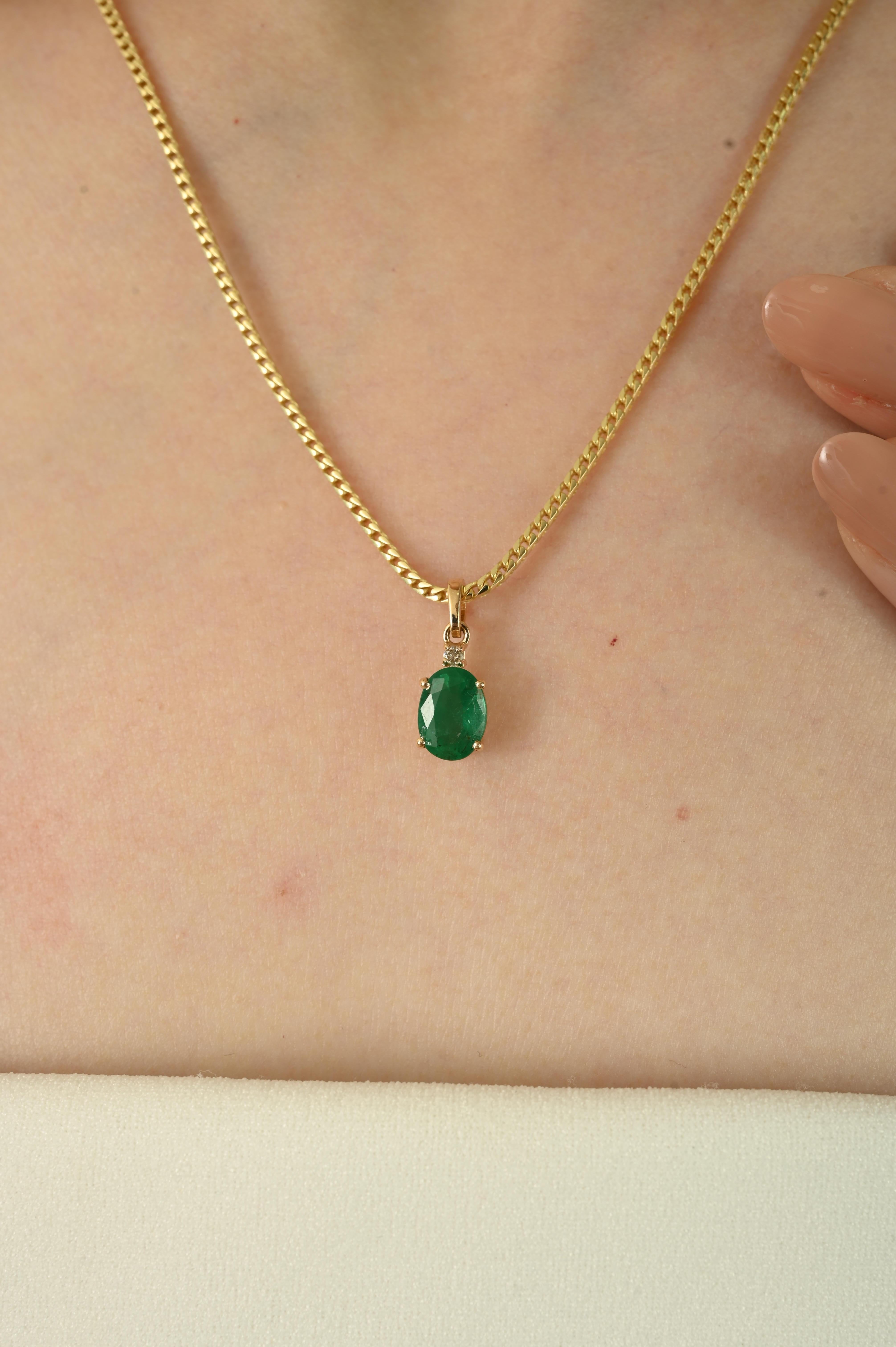 This pendant features a 1.28Ct natural Zambian emerald, cut in a classic oval shape and accented with round brilliant diamonds for added sparkle. Expertly set in 14K yellow gold with secure prong setting, the design highlights the vivid green