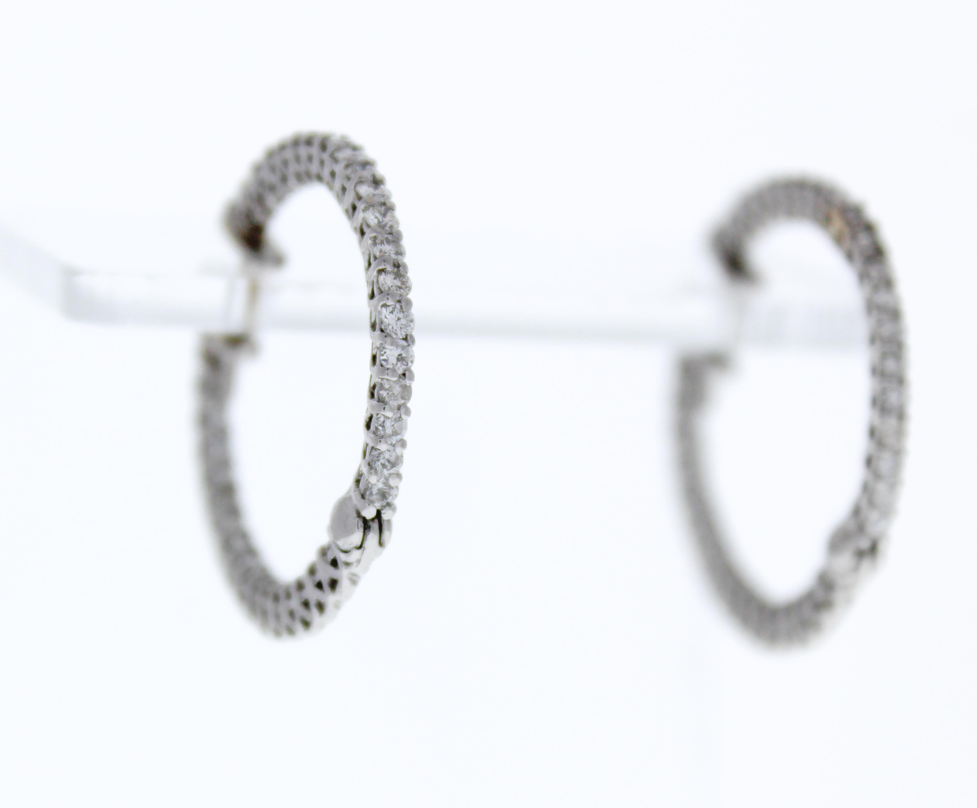 These diamond hoop earrings feature brilliant-cut diamonds totaling 1.44ctw, set in 14K white gold. The diamonds are placed in a trellis setting with 72 diamonds in total, creating a sparkling, elegant effect with diamonds on both the inside and