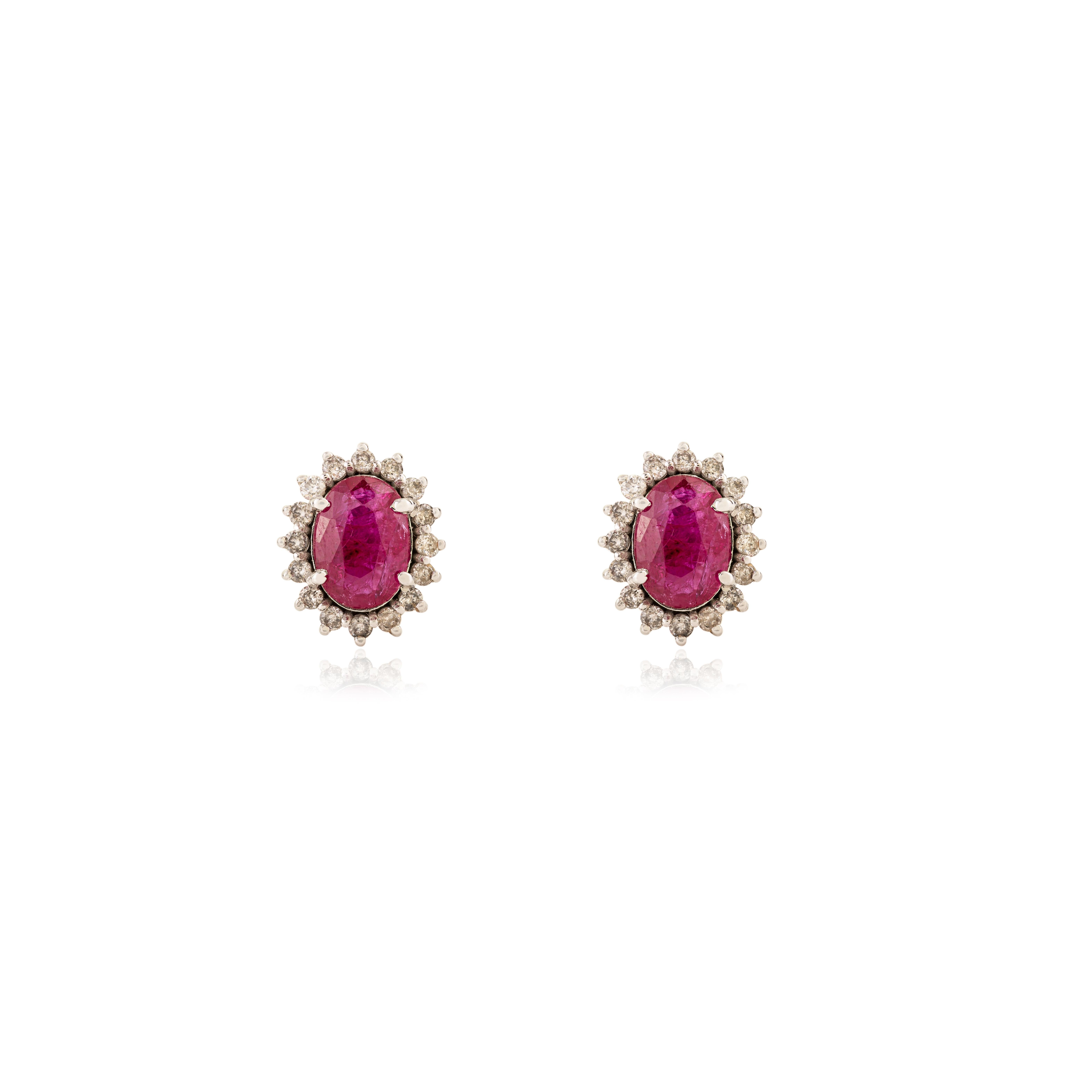 Contemporary Timeless 1.45 Carat Oval Cut Ruby & Diamond Halo Stud Earrings in 18K White Gold For Sale