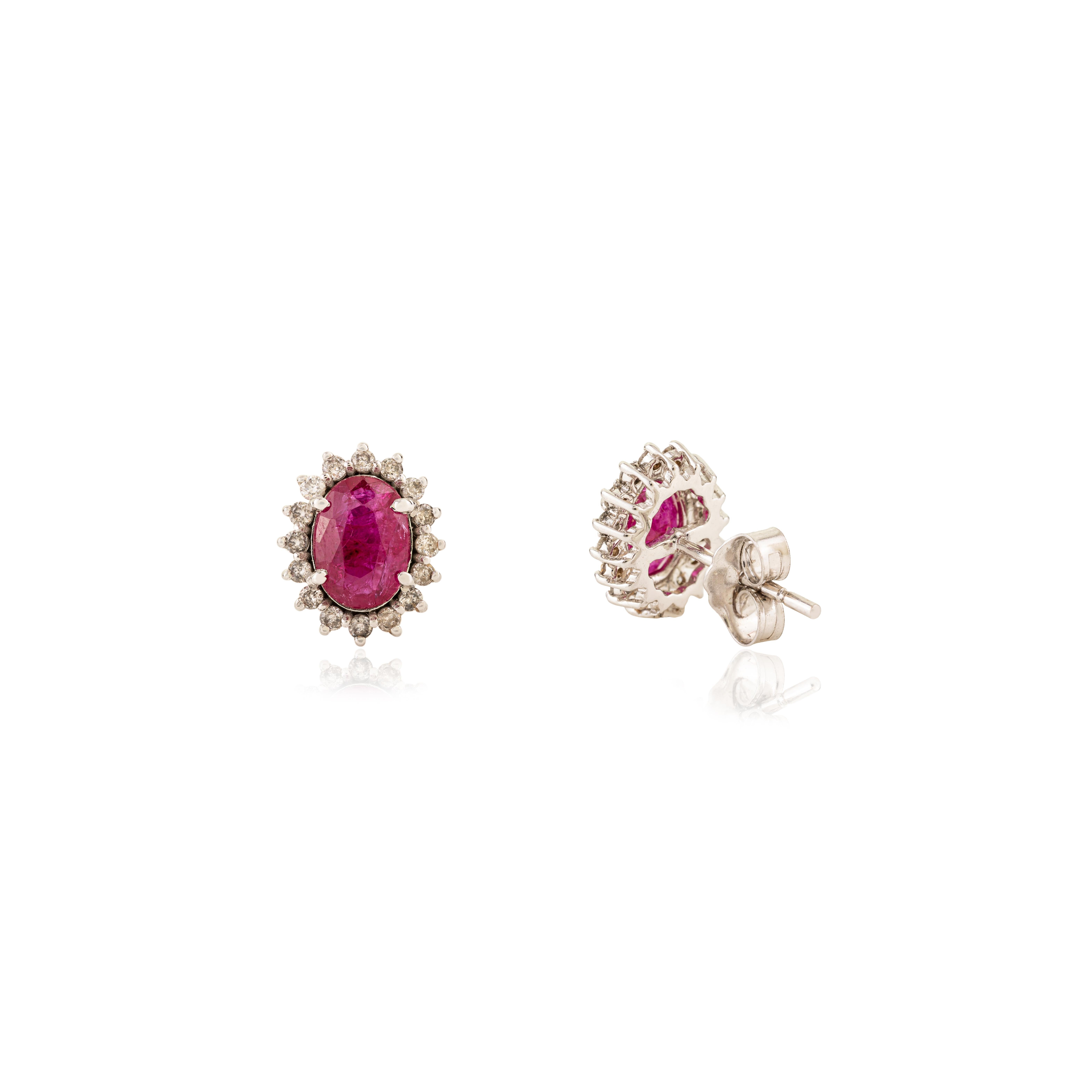 Women's Timeless 1.45 Carat Oval Cut Ruby & Diamond Halo Stud Earrings in 18K White Gold For Sale