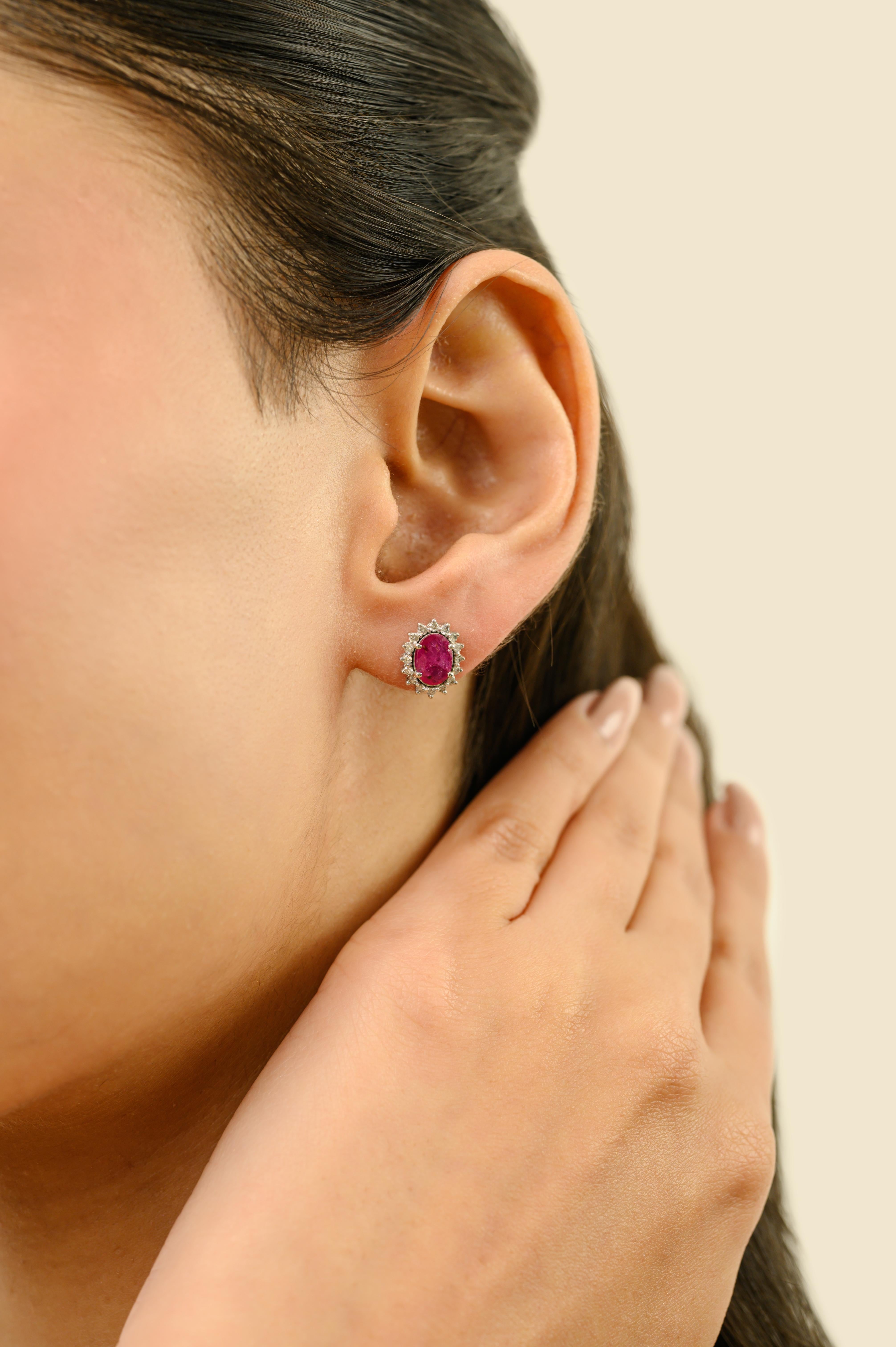 Timeless 1.45 Carat Oval Cut Ruby & Diamond Halo Stud Earrings in 18K White Gold For Sale 1