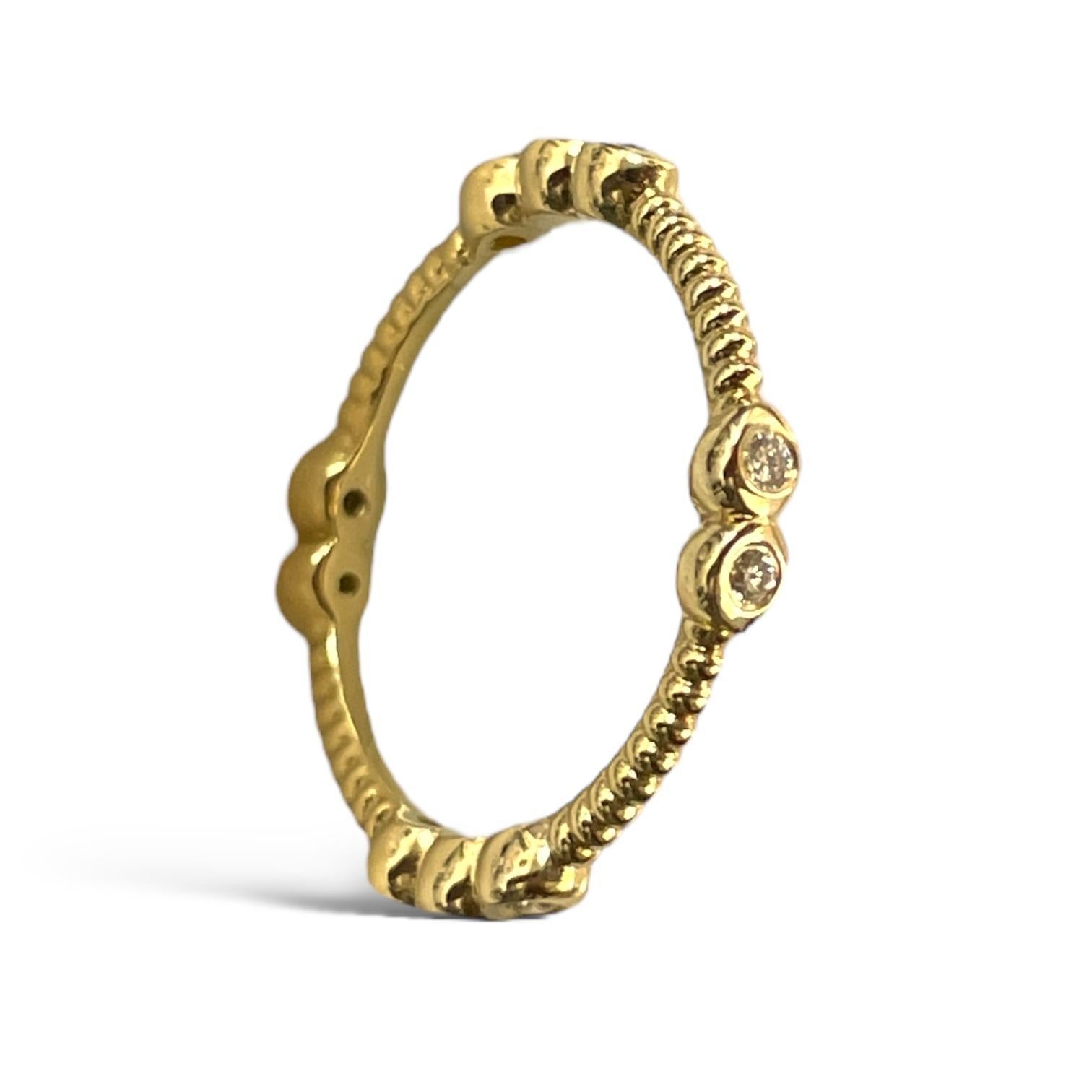 This exquisite 18K yellow gold ring showcases a beautiful beaded design, enhanced by round-cut diamonds set in a captivating arrangement. The delicate yet luxurious style makes it perfect for adding subtle sparkle to any outfit, whether worn alone