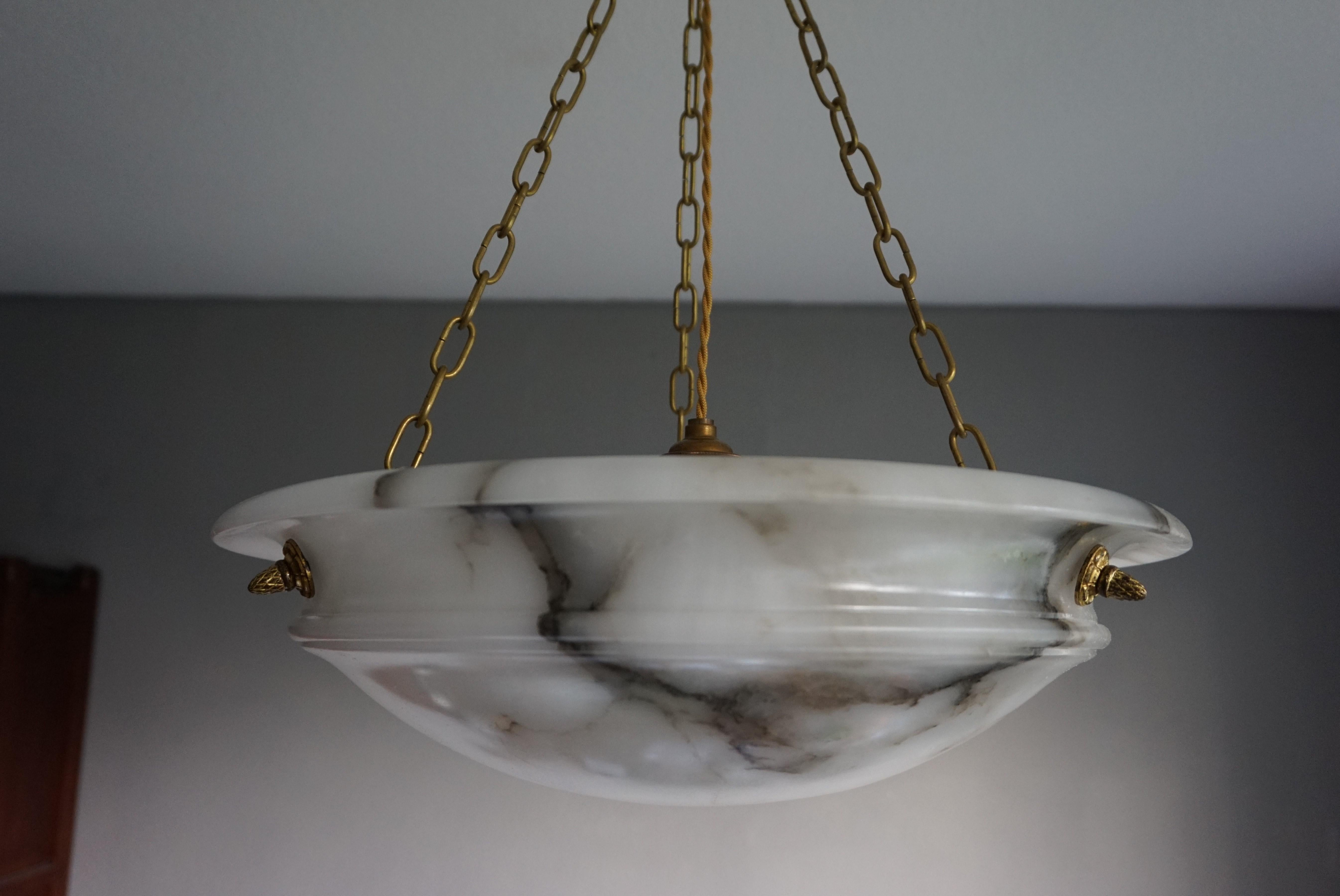 French Art Deco elegance for the collectors and enthousiasts.

If you are looking for a good size, beautiful, timeless and ready to use alabaster chandelier then this striking French specimen from circa 1920 could be gracing your home soon. The