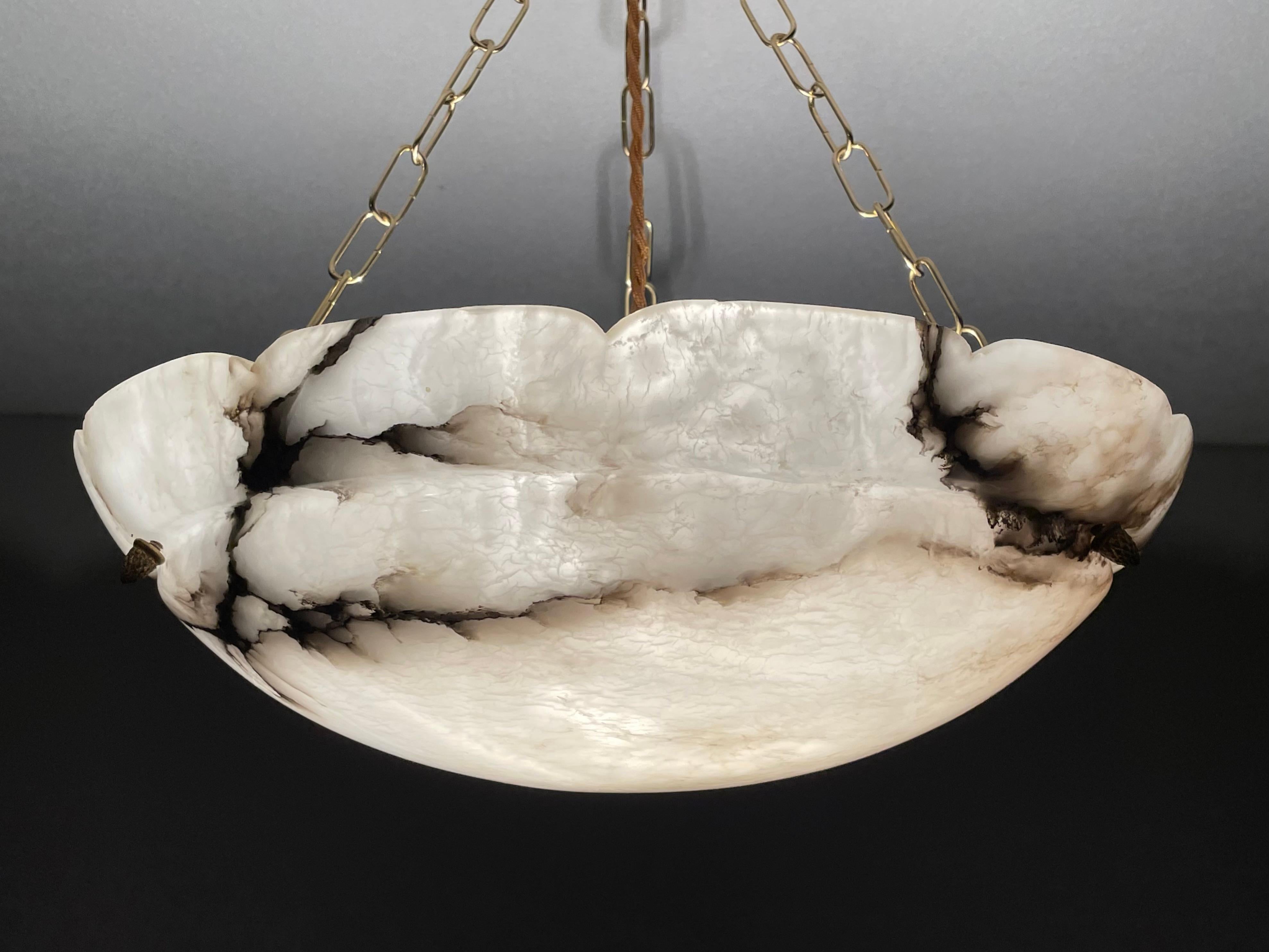 French Art Deco elegance for the collectors and enthousiasts.

If you are looking for a good size, beautiful, timeless and ready to use alabaster chandelier then this striking French specimen from circa 1910-1920 could be gracing your home soon. The