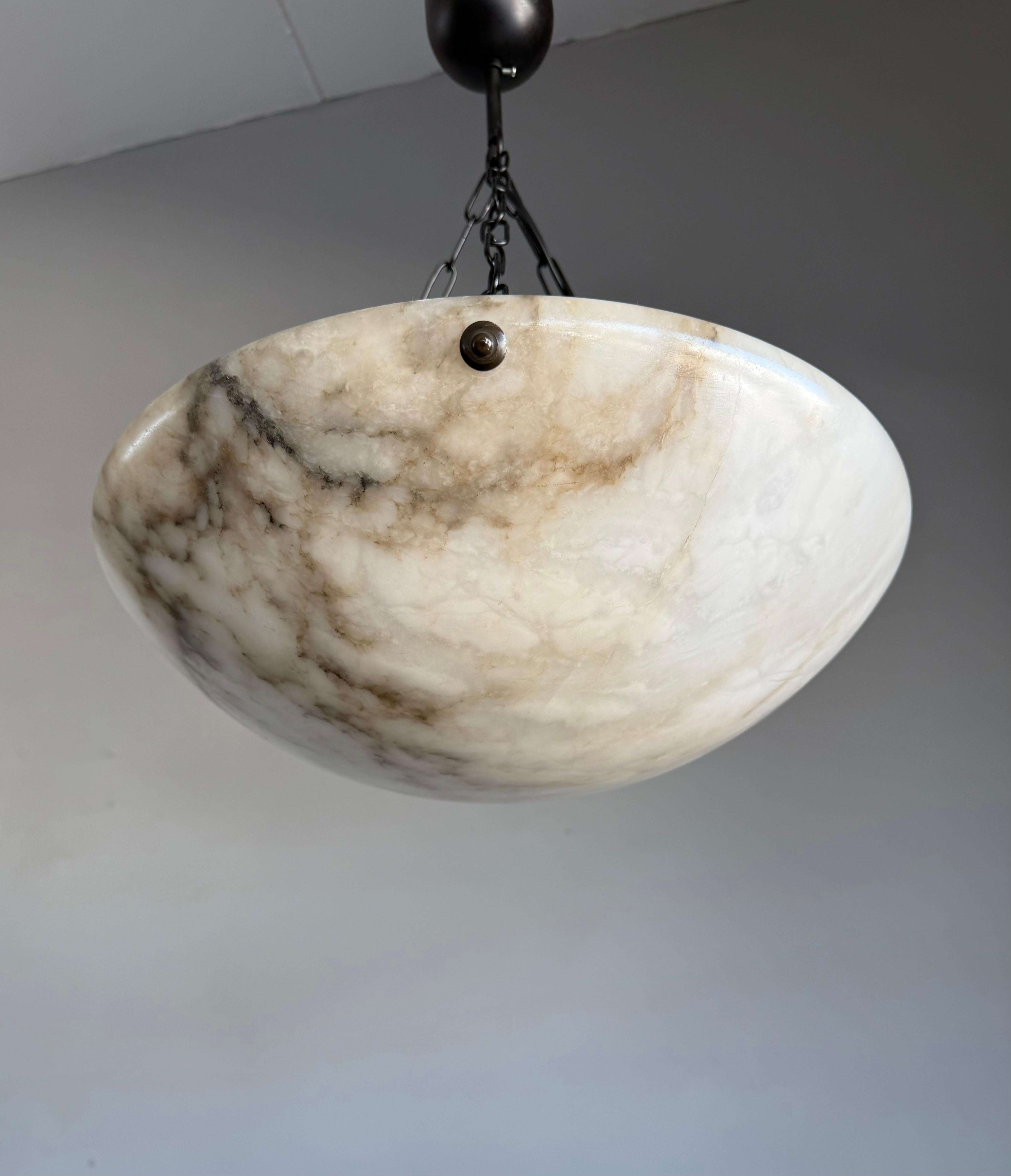 Perfect size and timeless Art Deco pendant that will never go out of style.

With early 20th century lighting as one of our specialities, finding an highly attractive fixture always makes our day. This perfect size specimen has one of the most