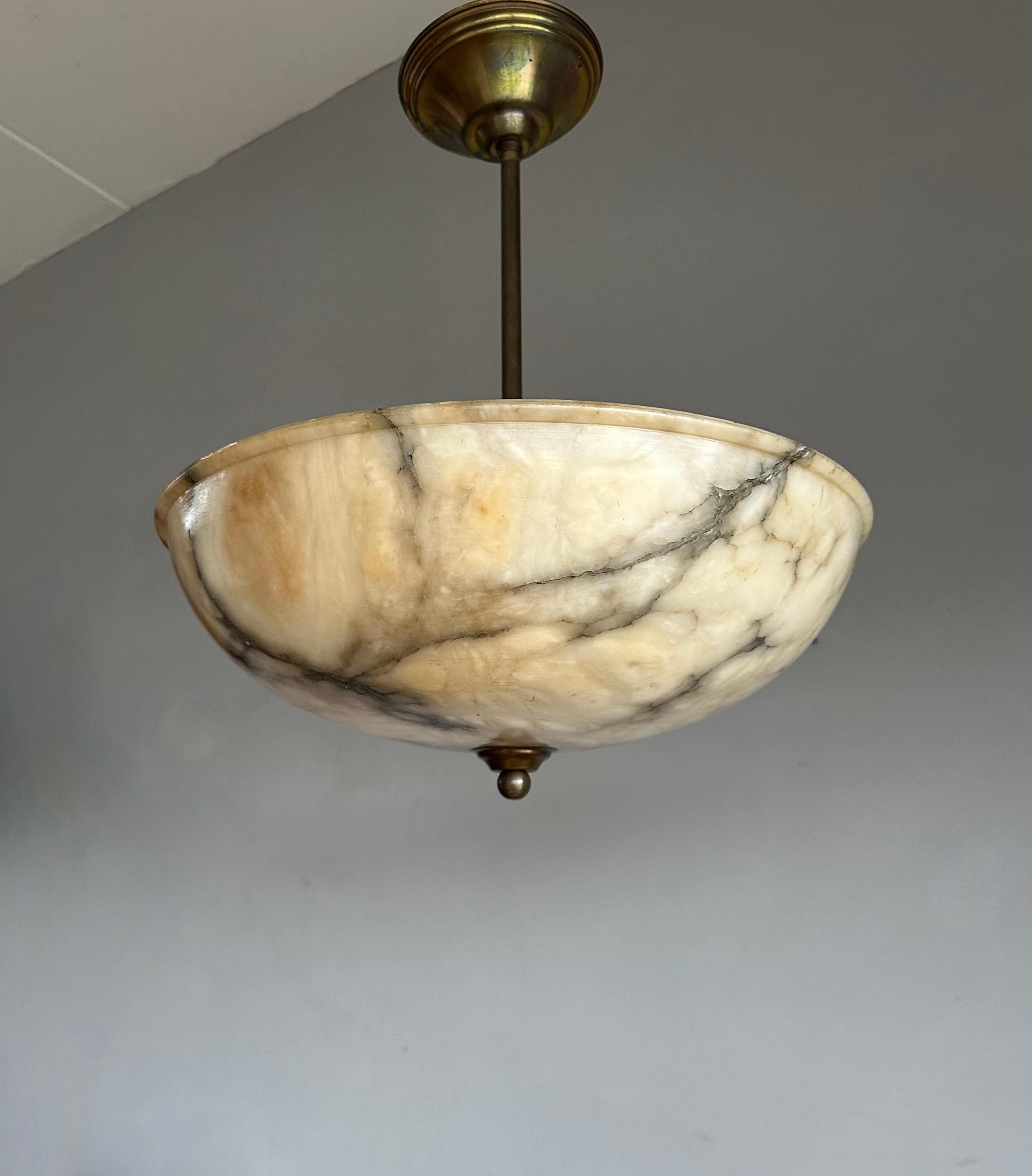 Timeless masterpiece and superb condition alabaster light fixture / flush mount.

Imagine a sultry evening in the 1920s as the warm glow of an exquisite alabaster pendant light fills the room. The brass details shimmer in the light, and the