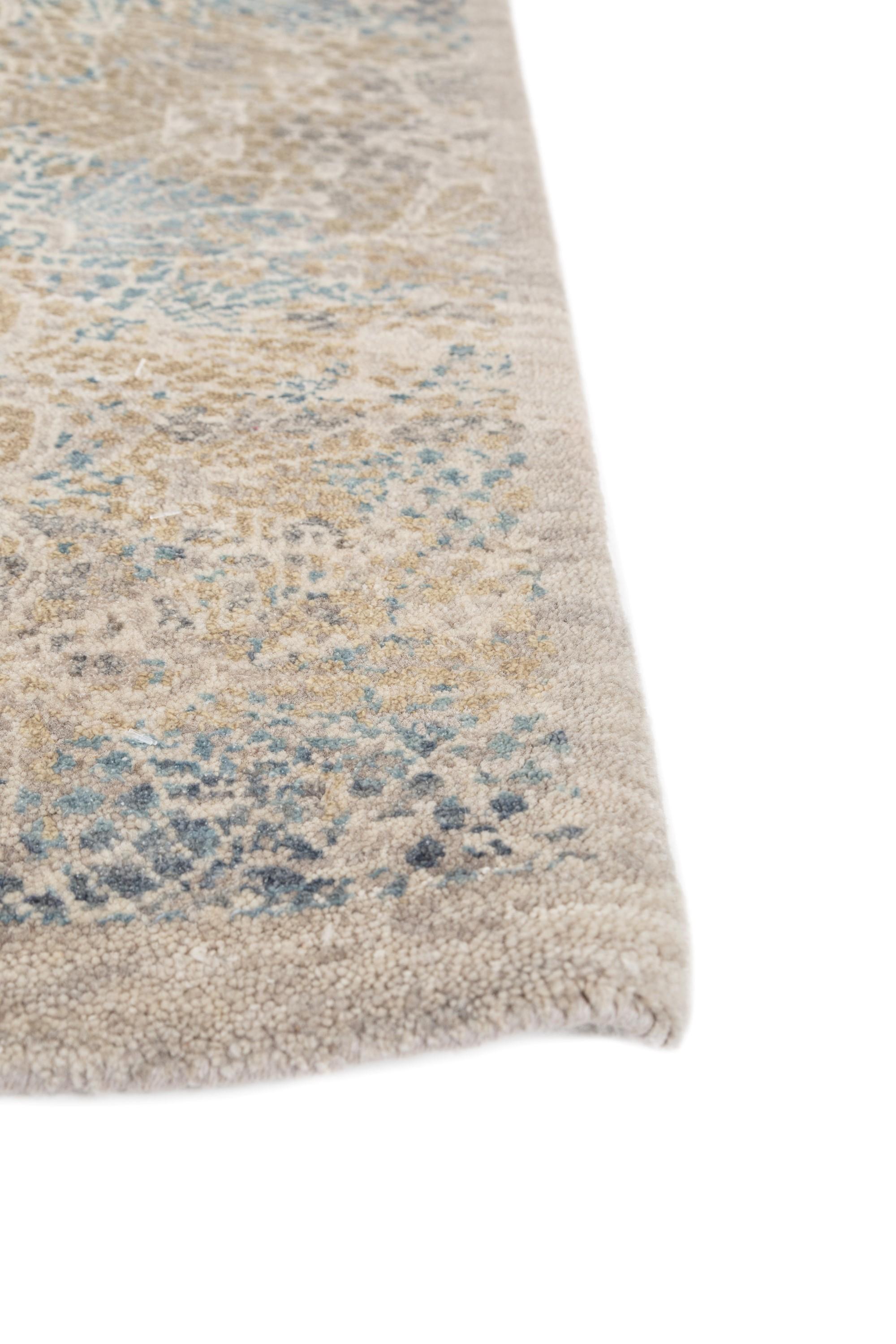 Immerse your home in the rich heritage of this hand-knotted rug that seamlessly weaves tradition and elegance. Crafted from a blend of wool and silk, this exquisite piece features intricate floral motifs within a traditional border design,