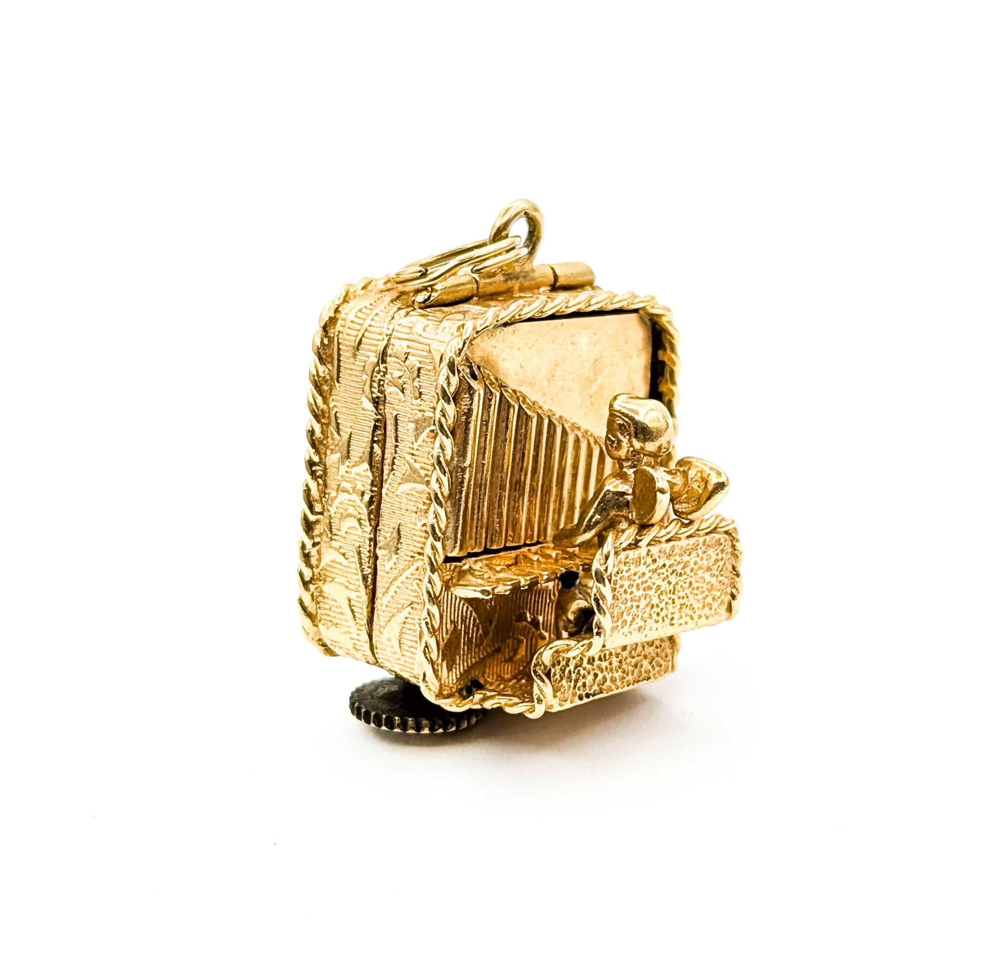 Ce magnifique pendentif en or jaune 14 carats est orné d'un chérubin jouant de l'orgue qui évoque la fantaisie et l'élégance. Le pendentif présente des détails exquis, capturant l'essence ludique du chérubin qui joue la sérénade avec son orgue