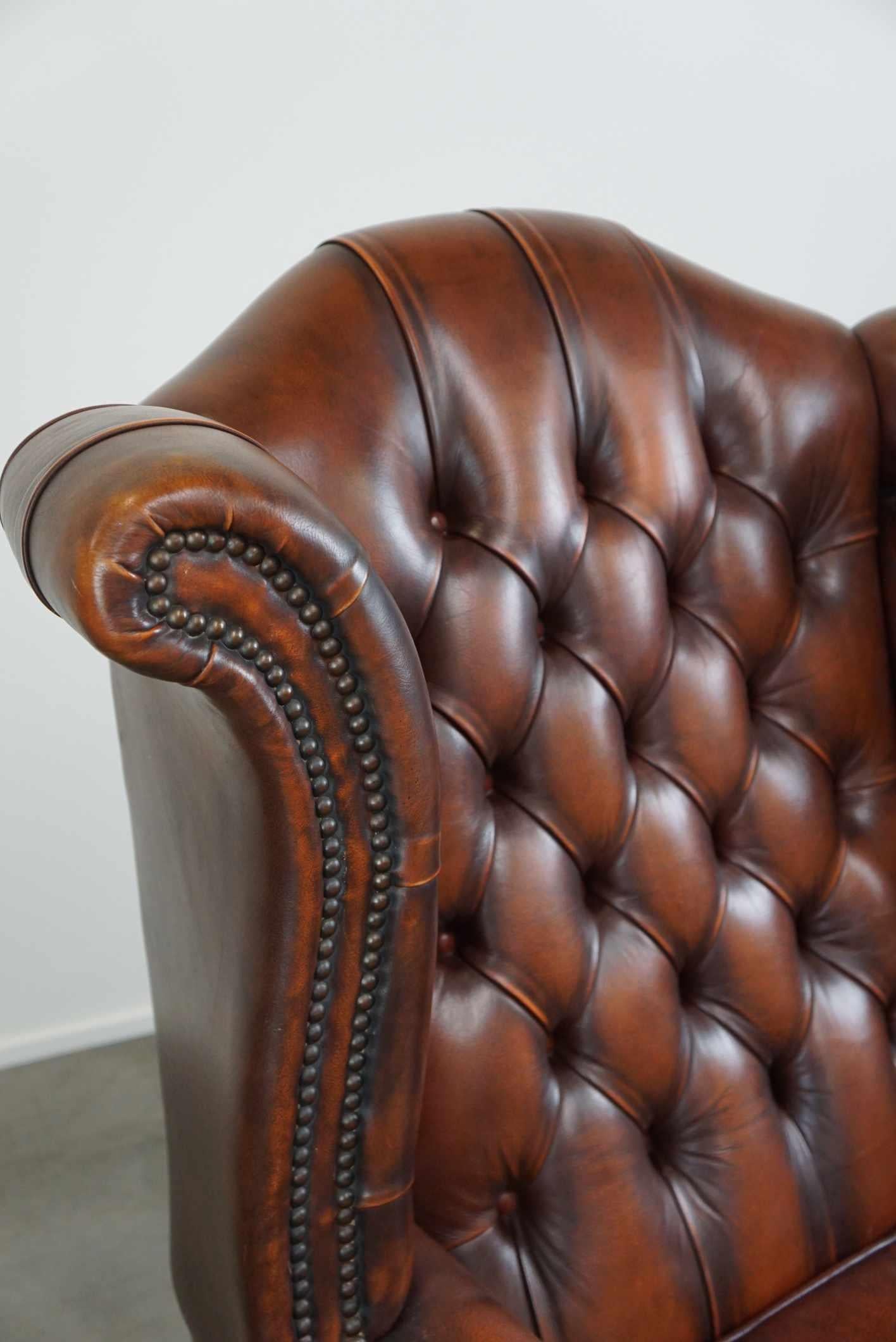 Timeless cognac-colored English cowhide Chesterfield wingback armchair in good c For Sale 3