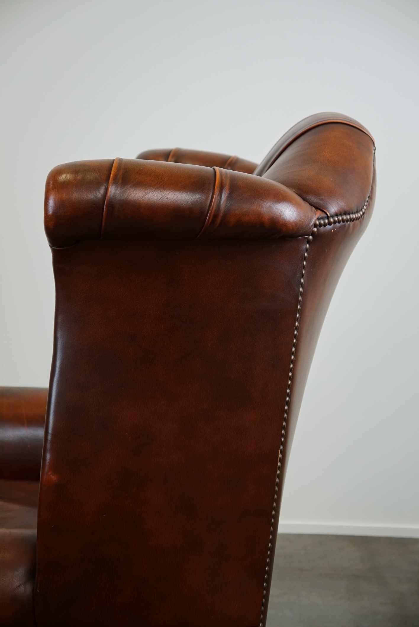 Timeless cognac-colored English cowhide Chesterfield wingback armchair in good c For Sale 6