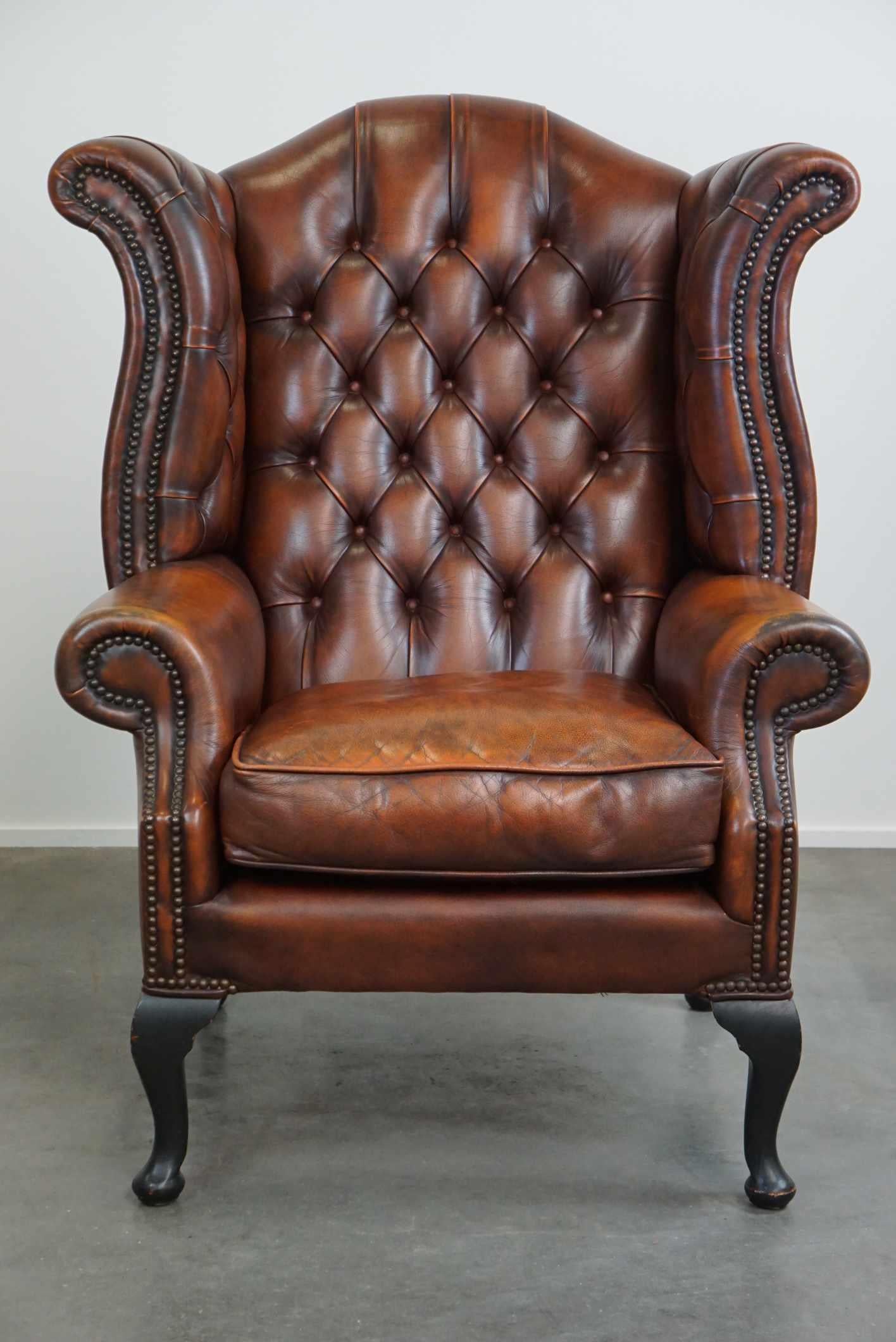 British Timeless cognac-colored English cowhide Chesterfield wingback armchair in good c For Sale