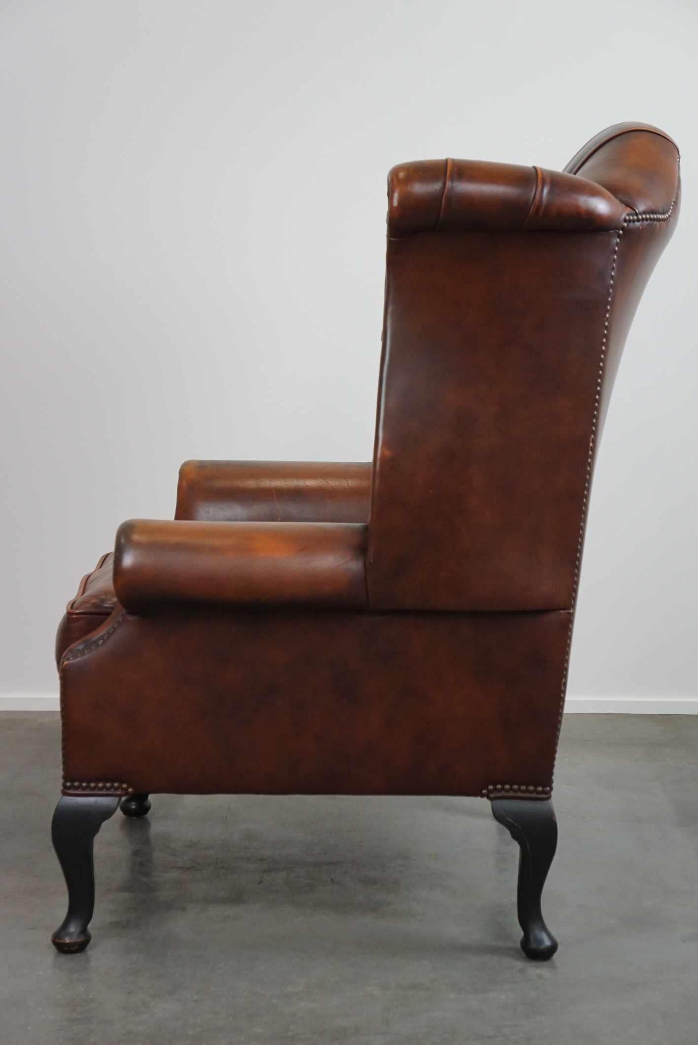 Timeless cognac-colored English cowhide Chesterfield wingback armchair in good c In Good Condition For Sale In Harderwijk, NL