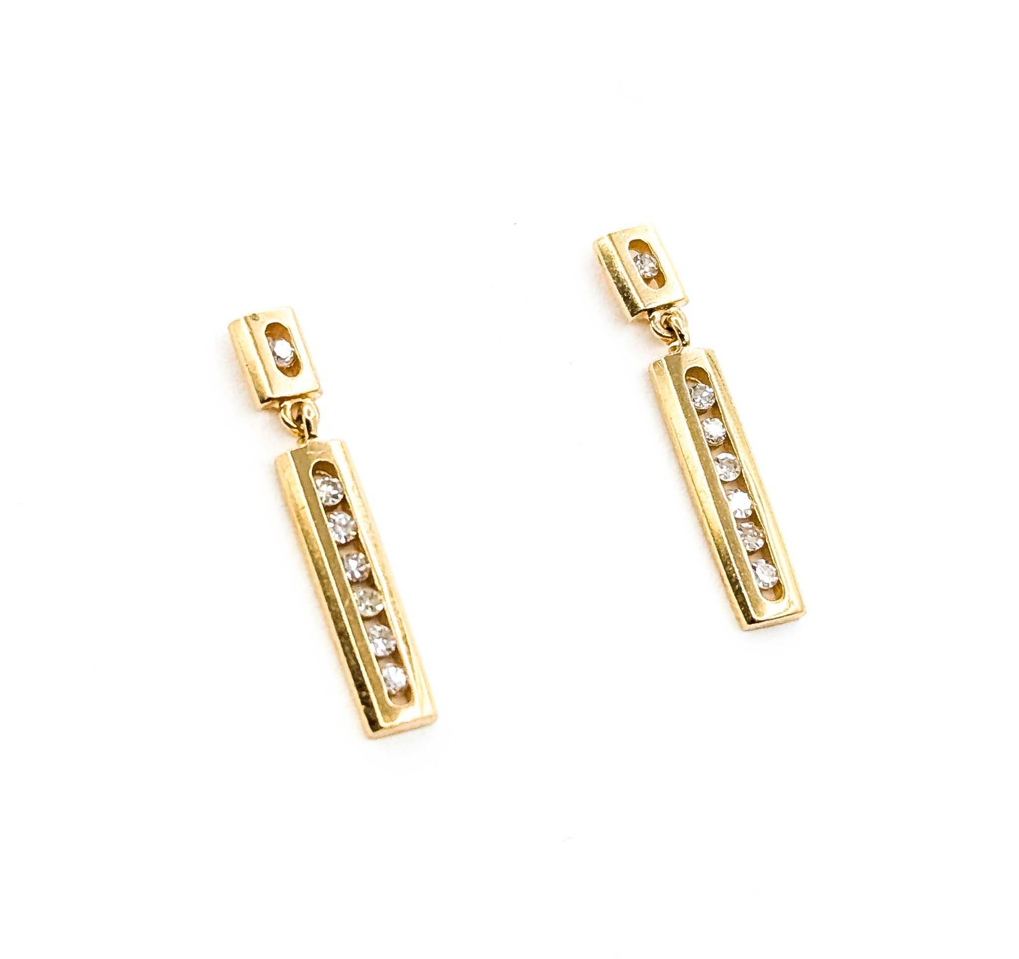 Introducing these exquisite diamond dangle bar earrings, meticulously crafted in 14K yellow gold. These elegant earrings feature a modern and sophisticated design, perfect for adding a touch of luxury to any outfit. The delicate dangle bars are