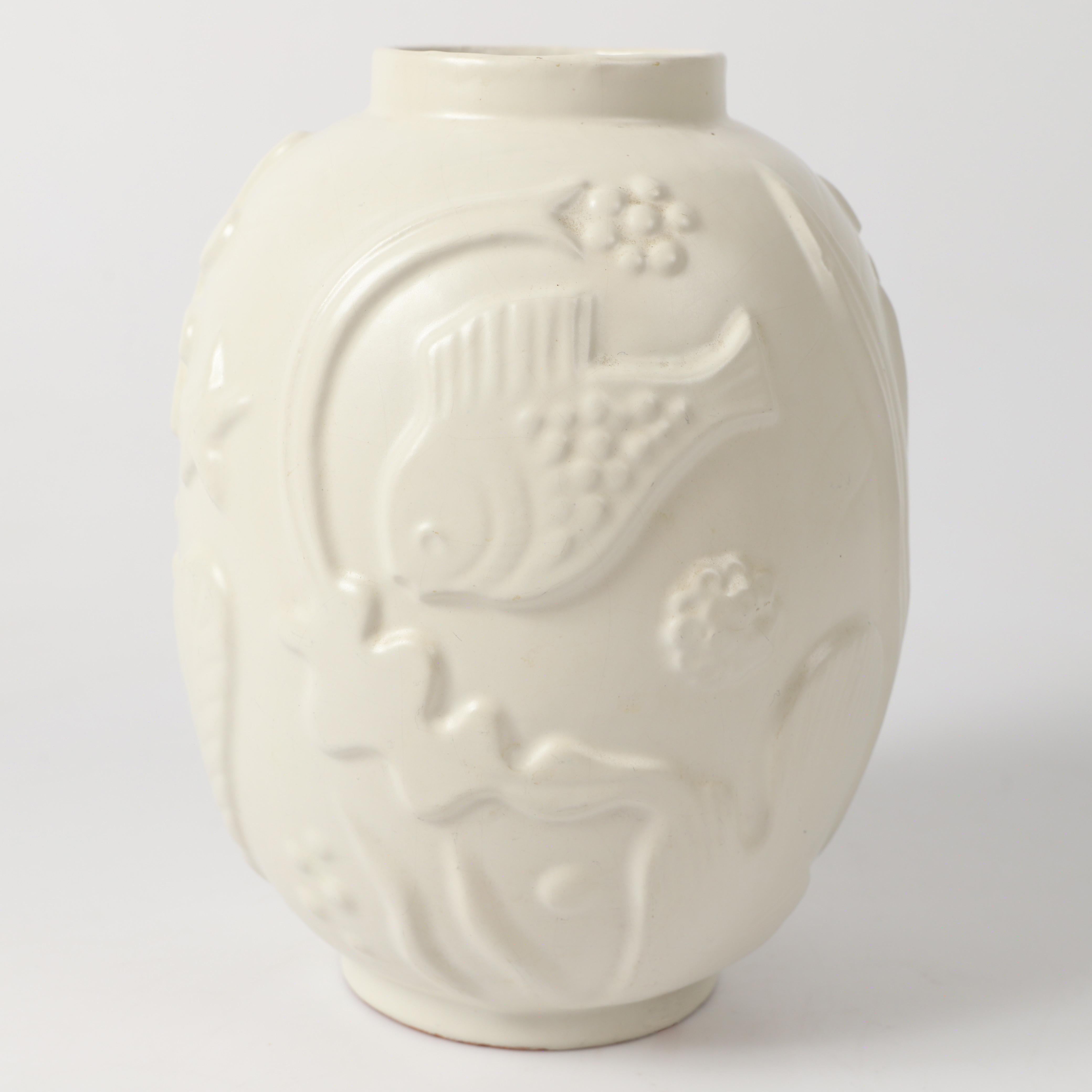 Vase en faïence, conçu par Anna-Lisa Thomson pour Upsala Ekeby dans les années 1930. Un travail exquis, des proportions harmonieuses accentuées par des décorations en relief complexes sur le thème de l'eau, le tout complété par une douce glaçure