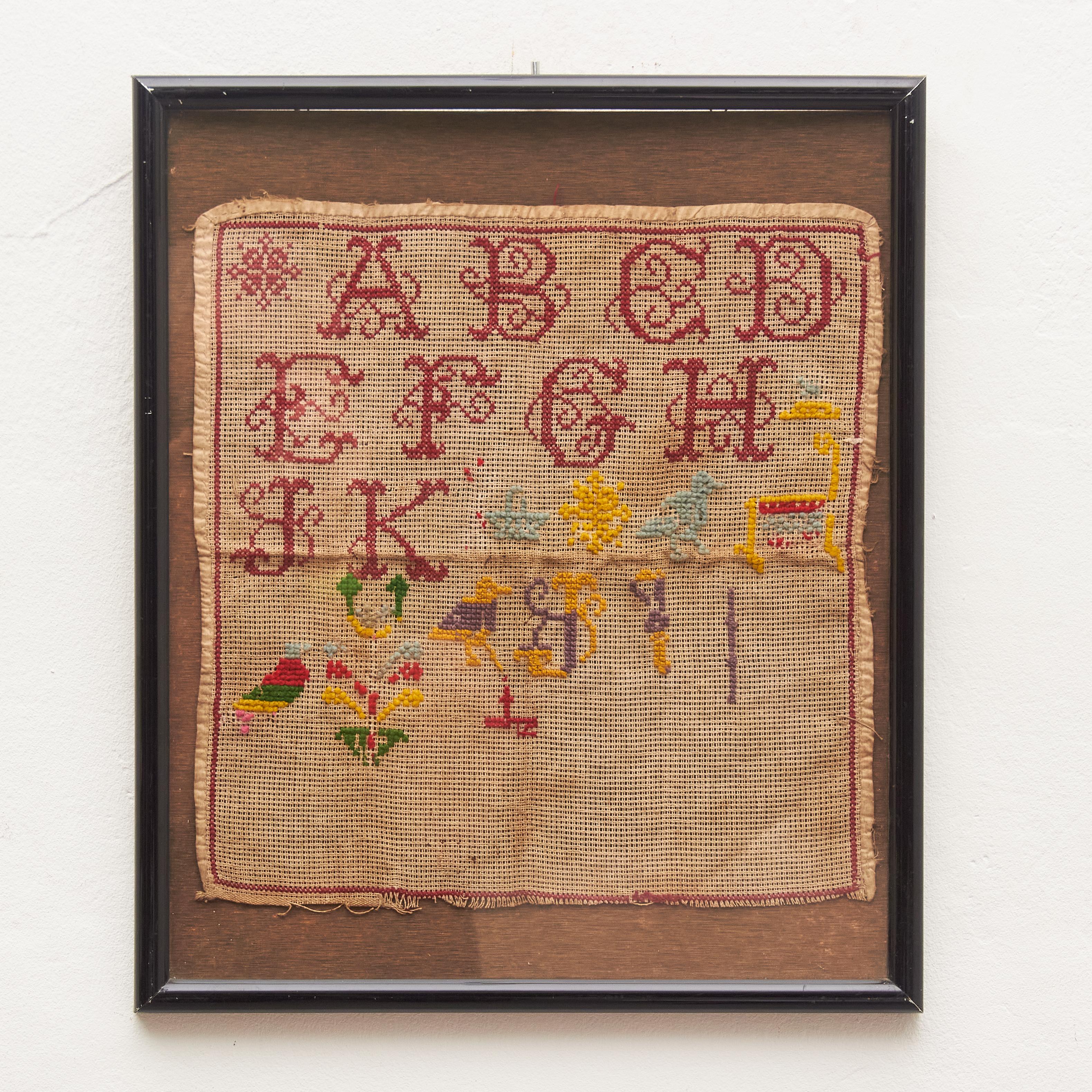 Immerse yourself in the enchanting beauty of our vintage cross-stitch sampler from the early 20th century. This singular piece boasts a classic red-on-white design with meticulously crafted alphabet letters, numbers, ornate borders, and a delightful