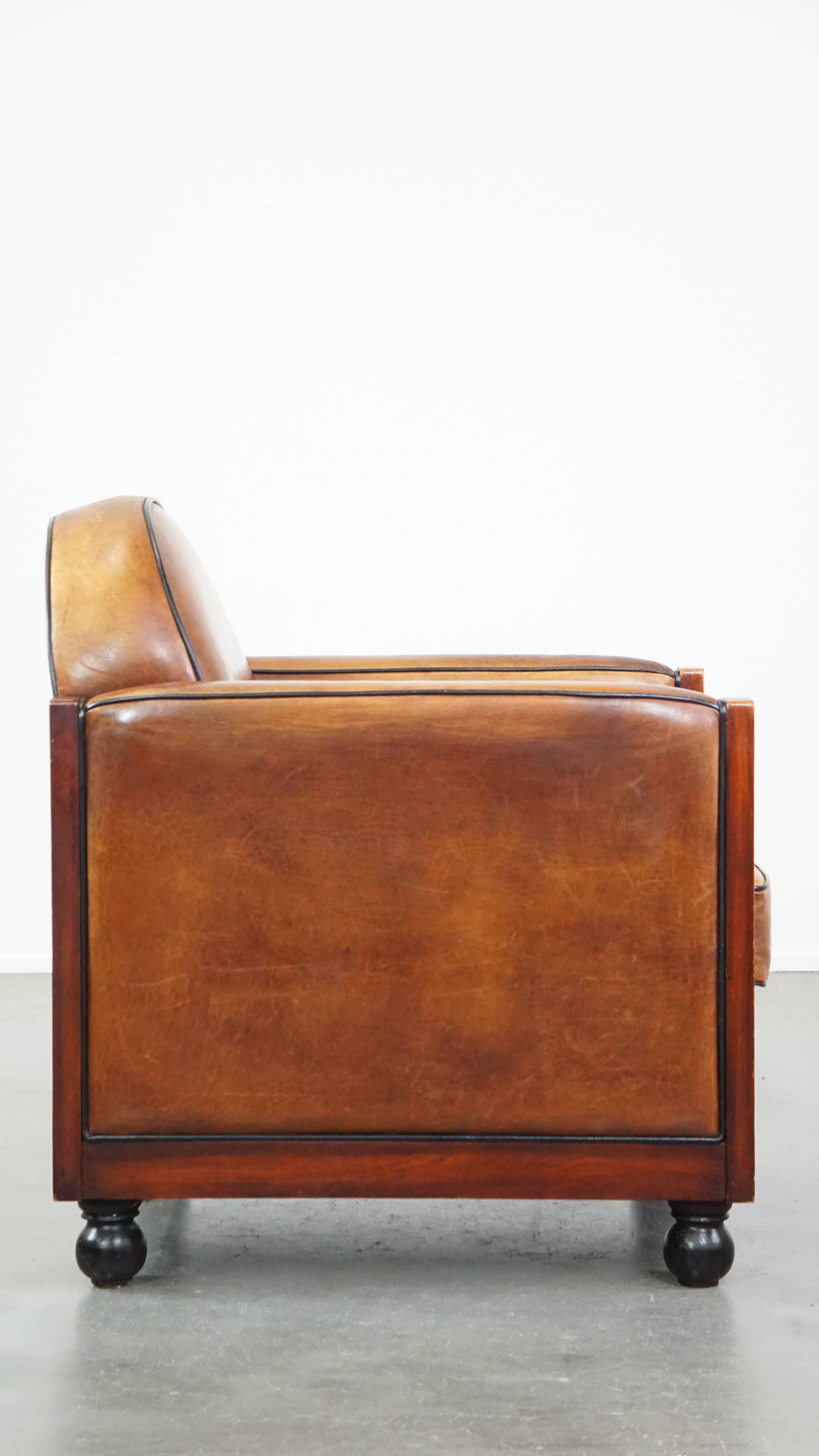 Hand-Crafted Timeless, finely crafted sheepskin leather and wooden Art Deco design armchair For Sale