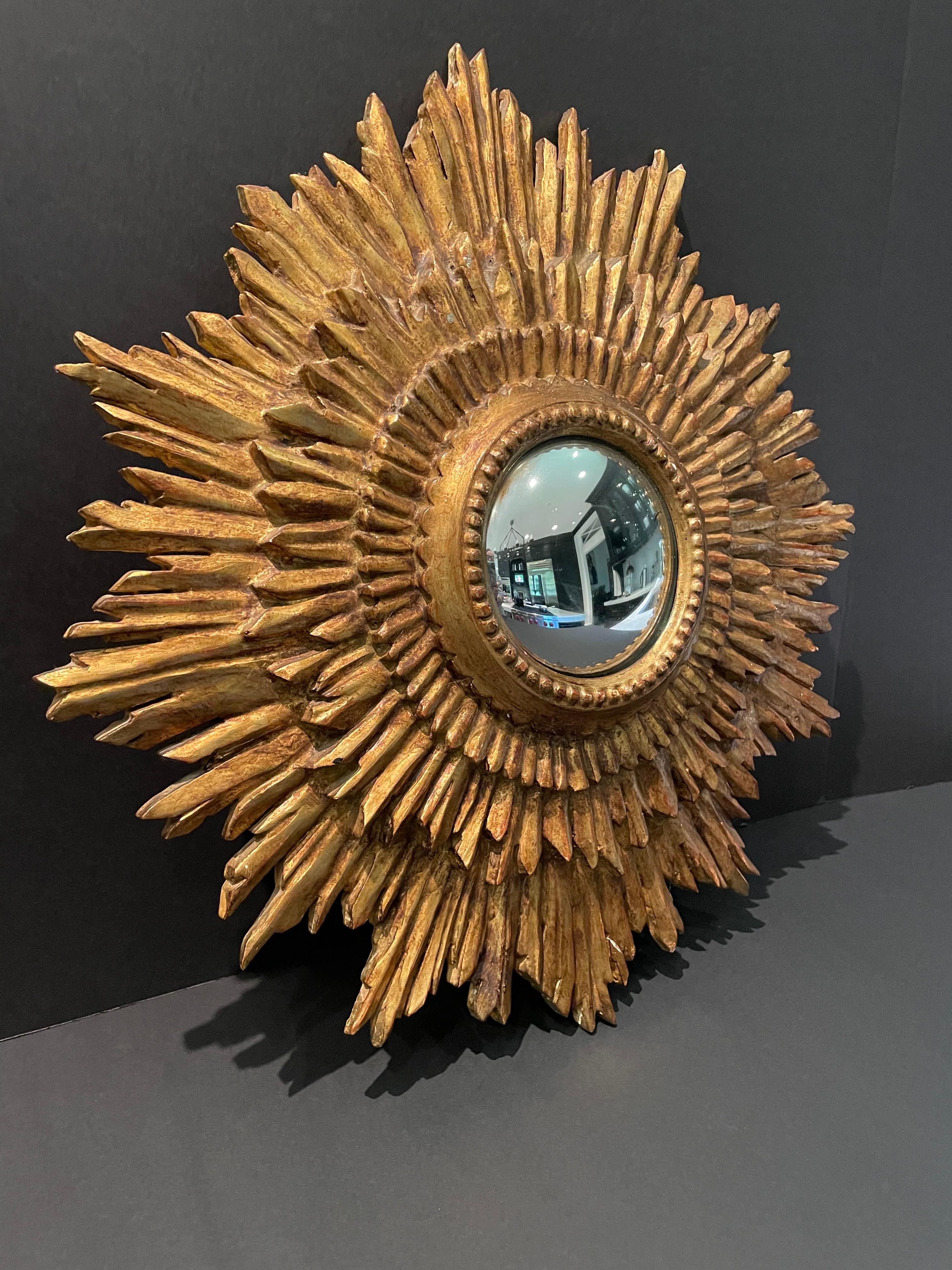 A fabulous example of a mid century convex giltwood sunburst mirror. Made in Italy.