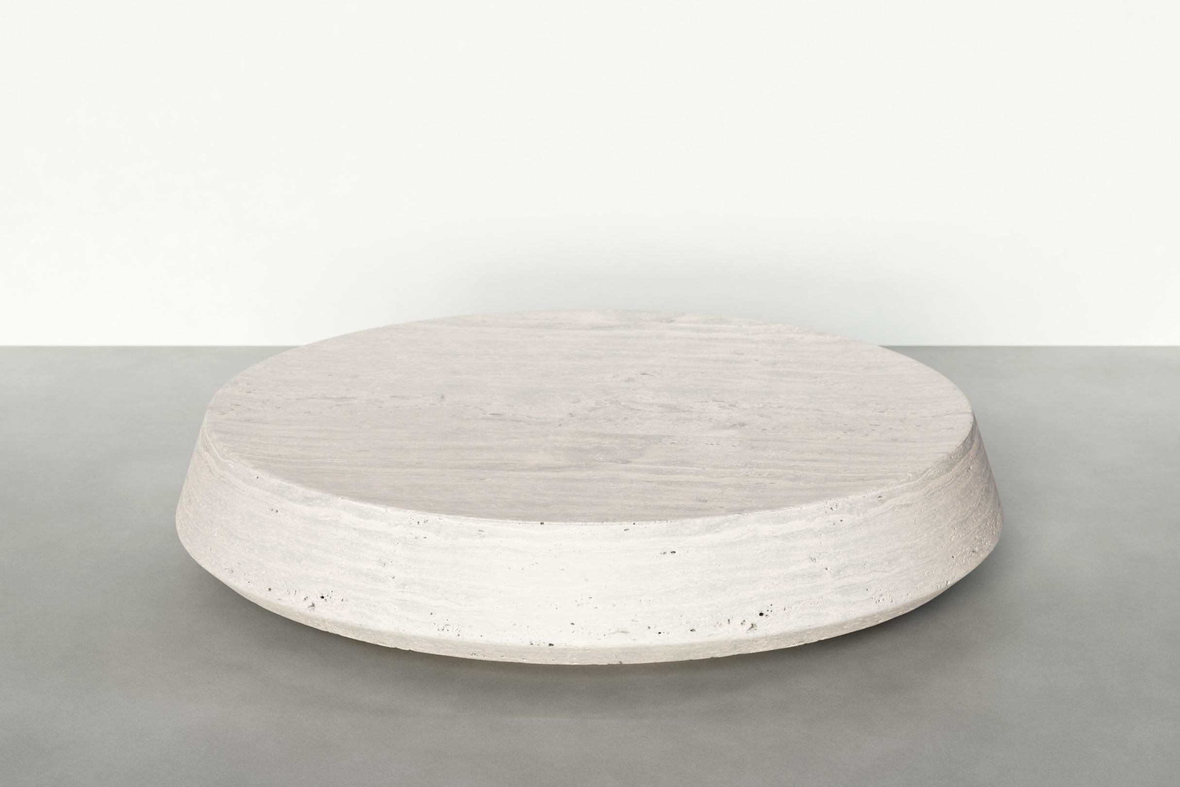 Timeless low table II by Maria Osminina
Limited Edition of 12
Dimensions: 95 x 95 x 20 cm
Materials: Travertino Romano

Timeless is a series of pieces of stone furniture in which the aesthetic vector is aimed at a deep sense of time as being. It is