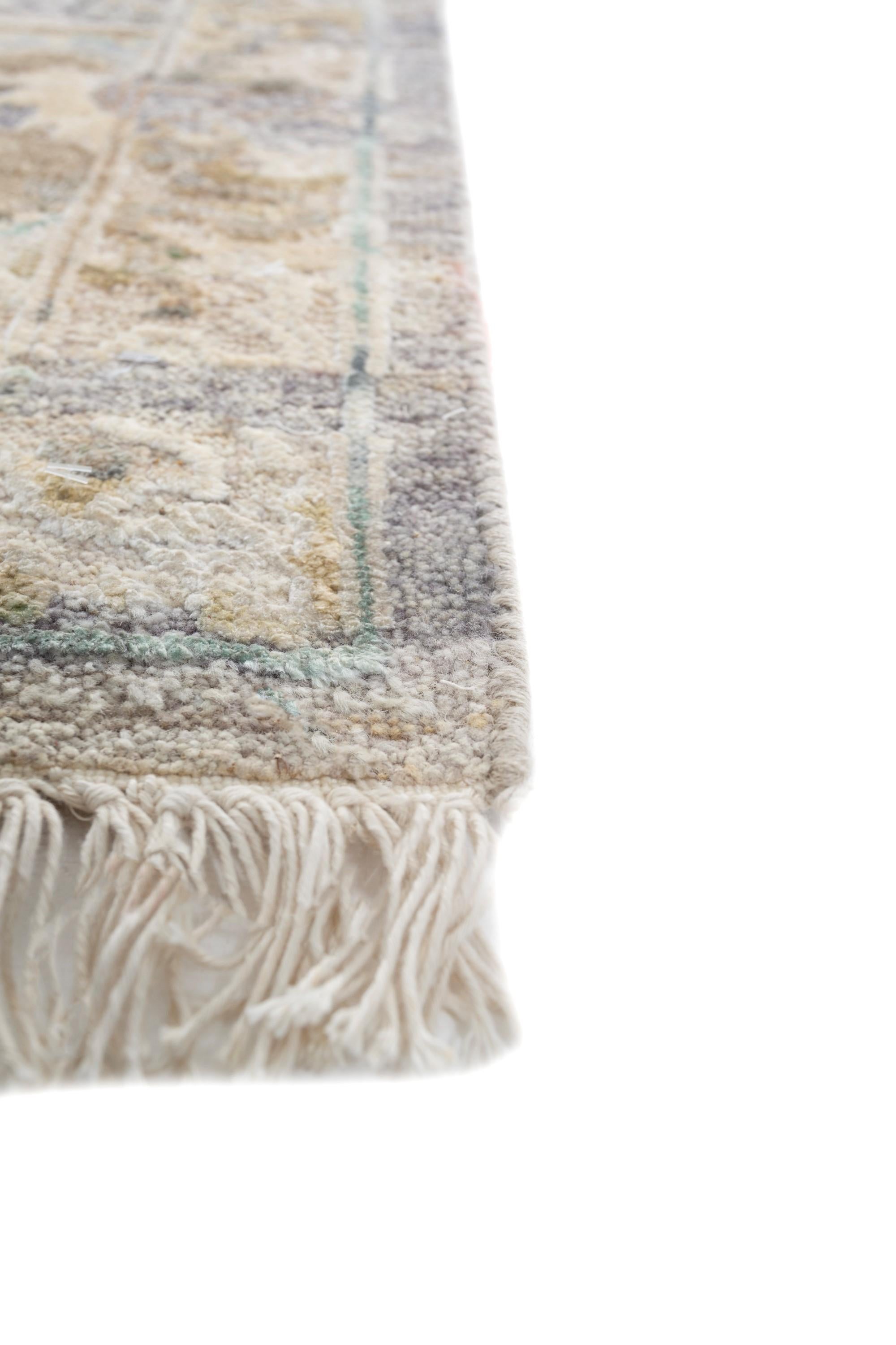 Immerse yourself in the timeless charm of our hand-knotted rug, a seamless blend of wool and silk thoughtfully curated  exclusively for you. The medium taupe base, reminiscent of earthy hues, effortlessly complements a dark ivory border, creating an