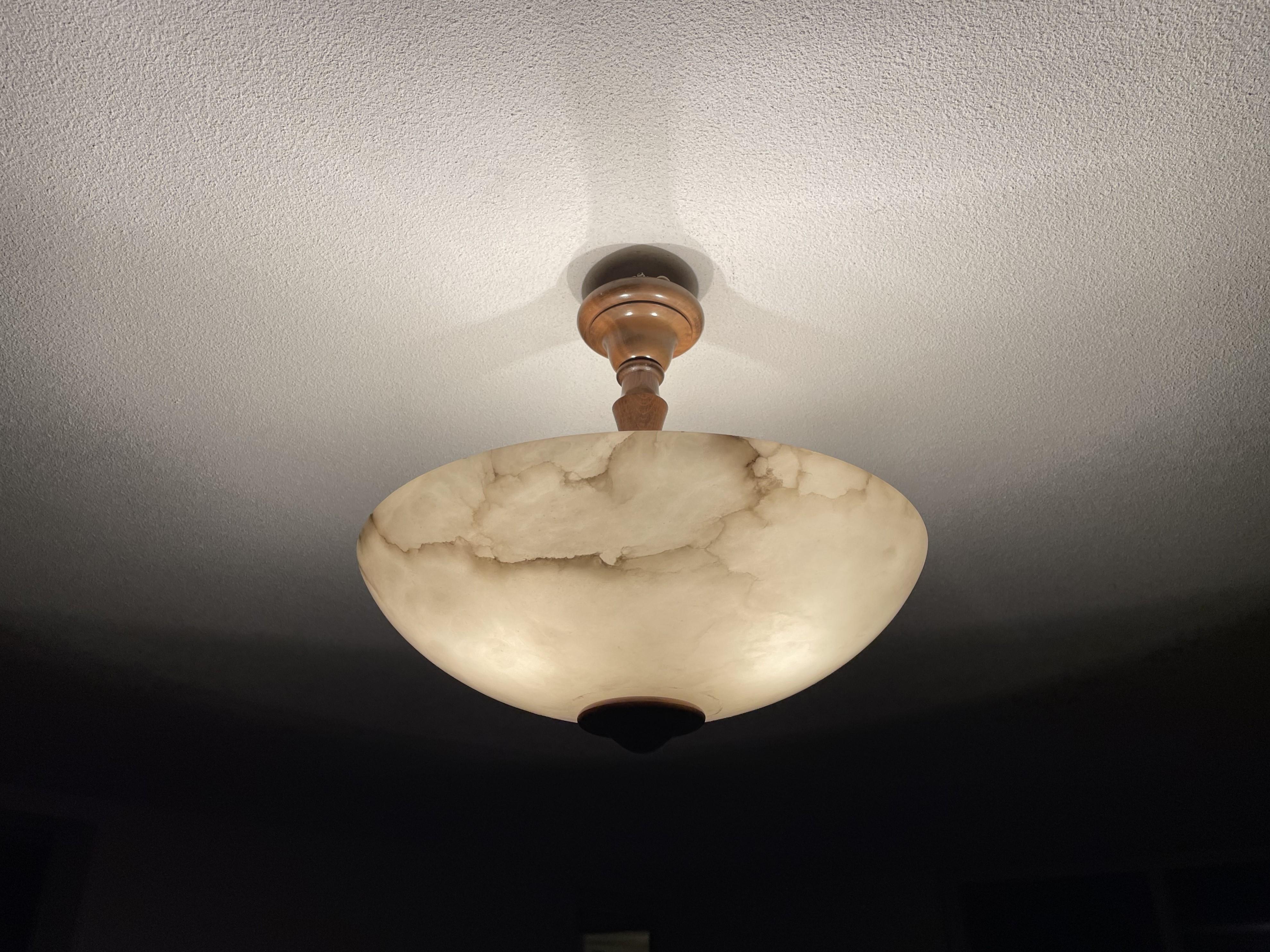 Timeless and very good condition alabaster light fixture.

The design and the perfect combination of materials make this mid-century made flush mount an absolute joy to own and look at. The near-mint condition of the alabaster shade with its perfect