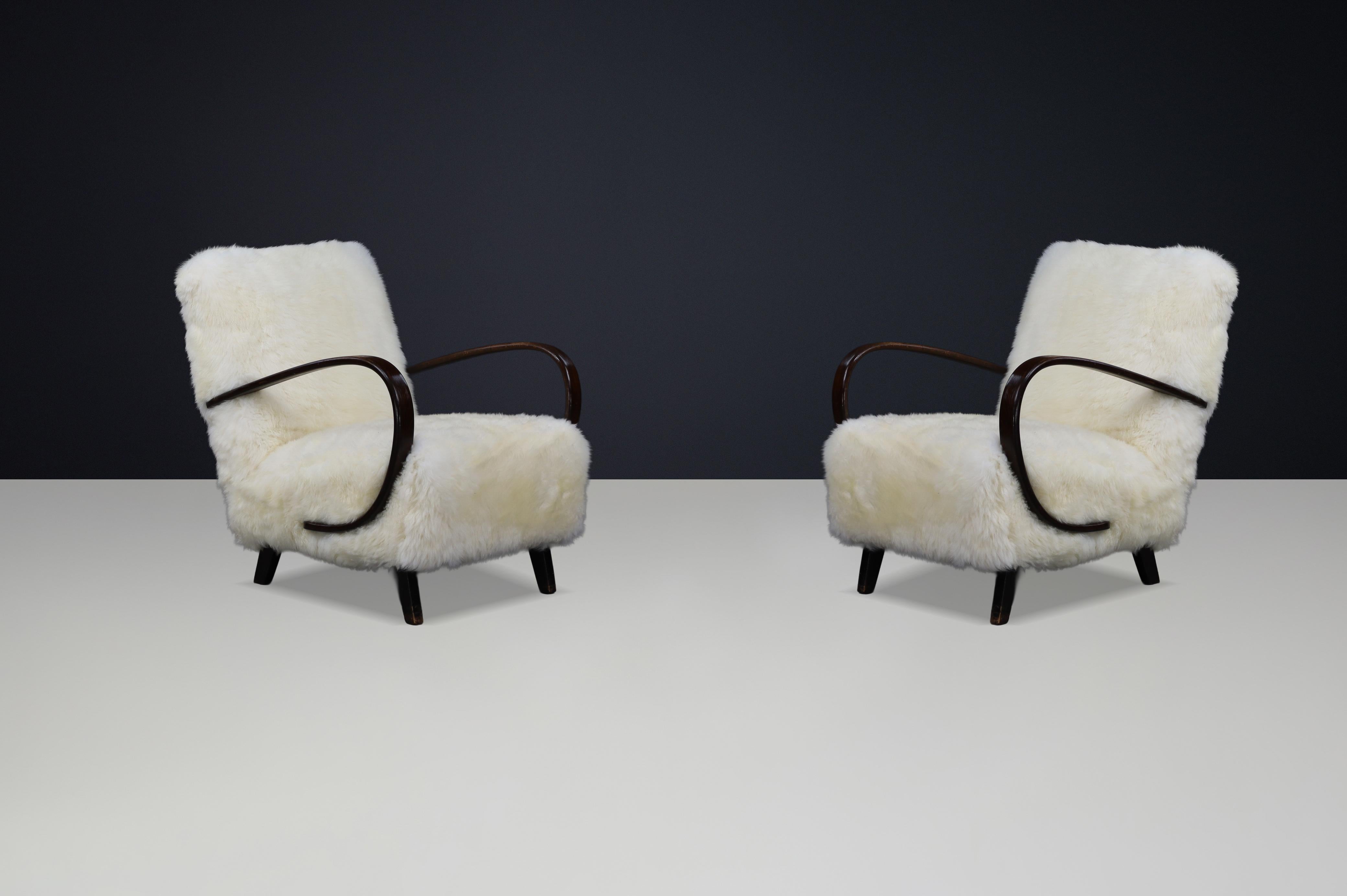 Timeless Pair of Jindřich Halabala Mid-Century Modern Sheepskin Lounge Chairs

A masterful expression of Czech modernism, this pair of lounge chairs by celebrated designer Jindřich Halabala captures the essence of mid-20th-century design: sculptural