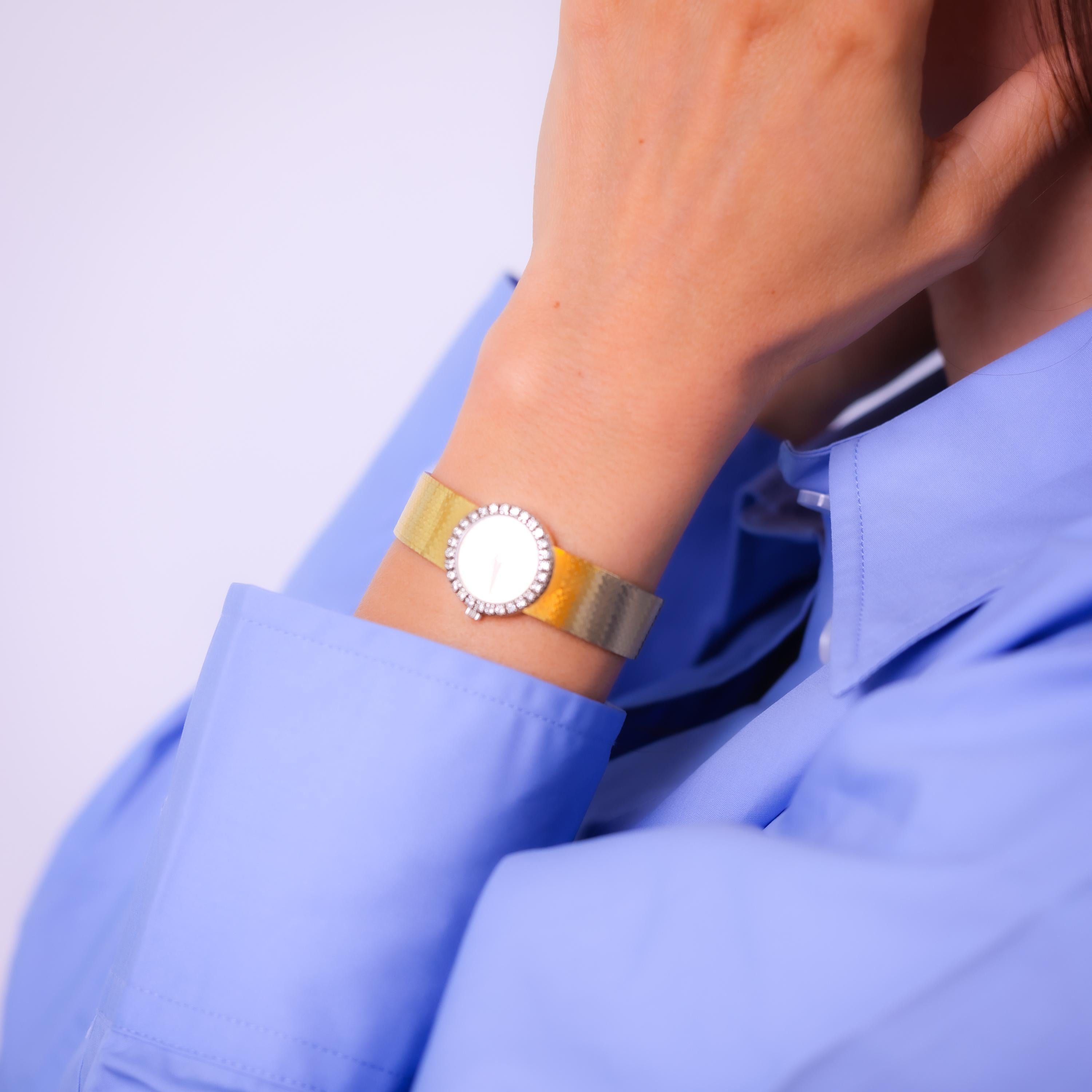 Brand: Piaget
Movement: Quartz
Center Stone: 28 round brilliant cut diamonds 
Weight: Approximately .90 carats 
Color: F-G
Clarity: VS
Metal: 18k yellow gold 
Era: Vintage
Circa: 1990's
Hallmarks: Signed, numbered
Size: 6 inches in length 
Gram