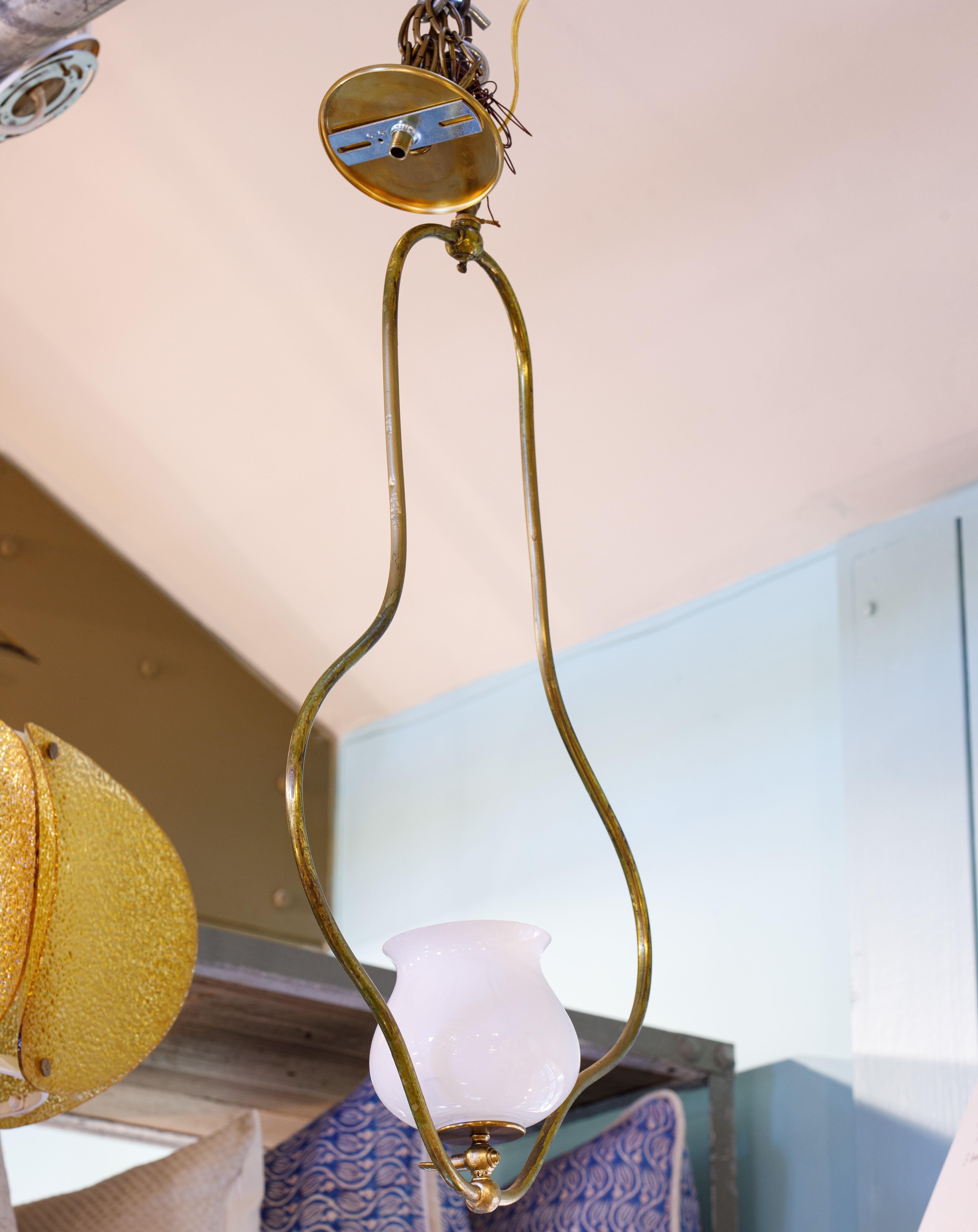 This brass and opaline glass pendant or lantern has a very timeless appeal.  It would be suitable for an entryway, hallway or staircase.  The simple style is compatible with just about any other style.  This style of light is sometimes referred to
