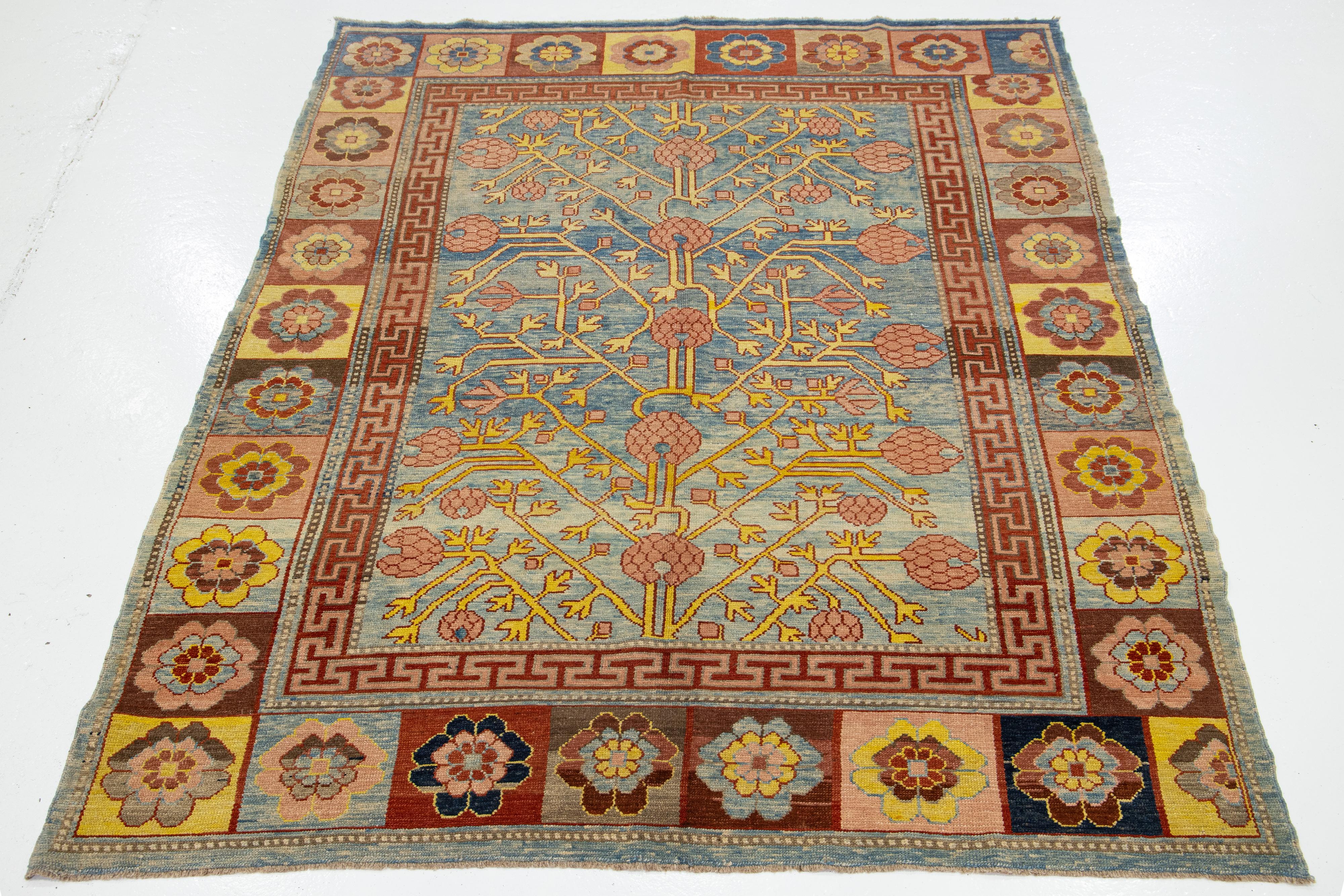 Experience the timeless elegance of a 1990s Vintage Khotan-style hand-knotted wool rug. This rug is part of our Revival Collection and features a striking blue field complemented by multi-color accents, all woven into an intricate all-over geometric