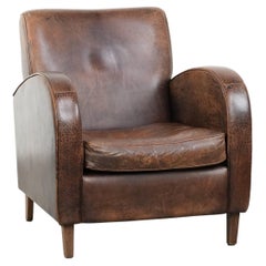 Timeless vintage sheepskin design armchair in a dark cognac colour