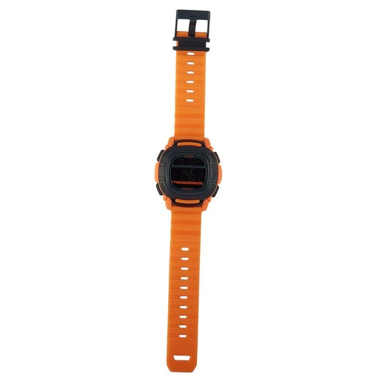 This is the Timex Commandâ„¢ 47 mm, reference number TW5M26500. The watch is presented with a 47 mm orange resin case with black accents that boasts stainless steel back. The case is built to ISO shock-resistant standards and is water-resistant to