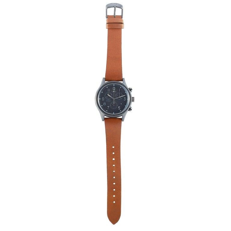 This is the Timex MK1 Supernovaâ„¢ Chronograph 42 mm, reference number TW2T29600. The watch is presented with a 42 mm stainless steel case that is mounted onto a brown leather strap, secured on the wrist with a tang buckle. The case offers water