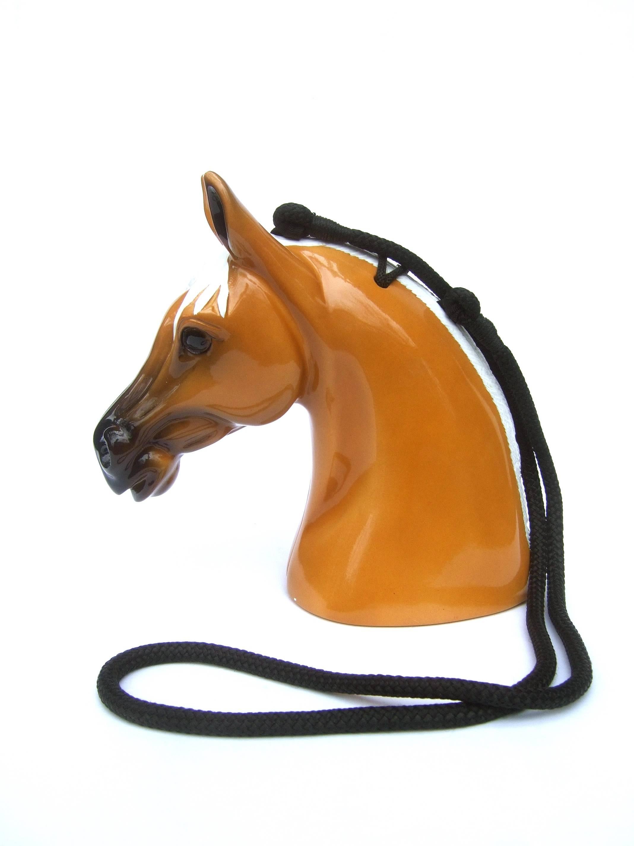 Timmy Woods Beverly Hills Wood artisan equine handbag c 1990s
The unique hand carved wood horse theme handbag is sheathed 
in glossy caramel color light brown enamel on one side

The other side profile is white enamel emulating the mane with sinuous