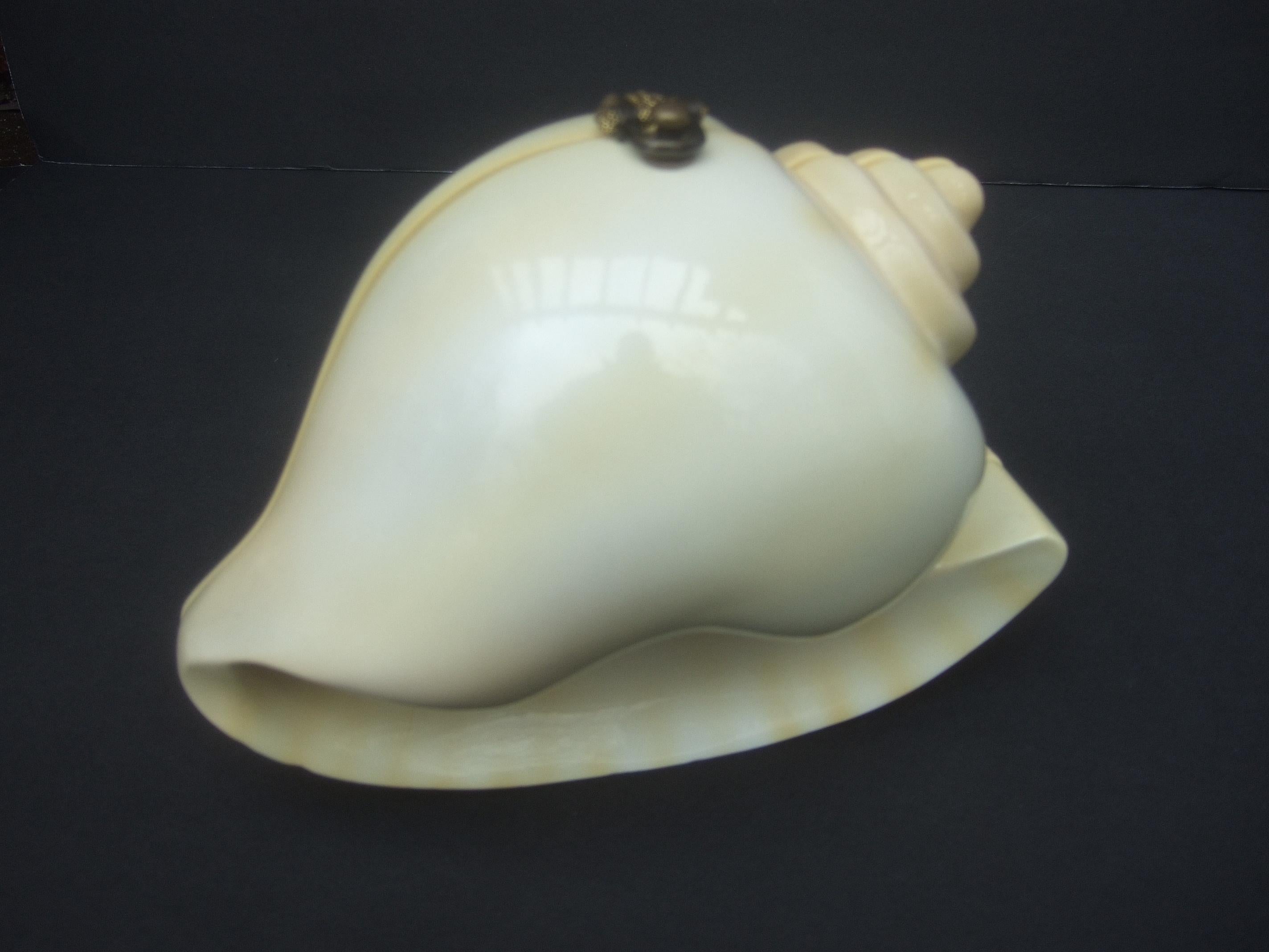 Timmy Woods Beverly Hills hand carved wood enamel conch shell artisan handbag c 1990s
The unique hand carved wood shell handbag is sheathed in a smooth cream color enamel 
lacquer with subtle streaks of pale yellow enamel

The versatile handbag may