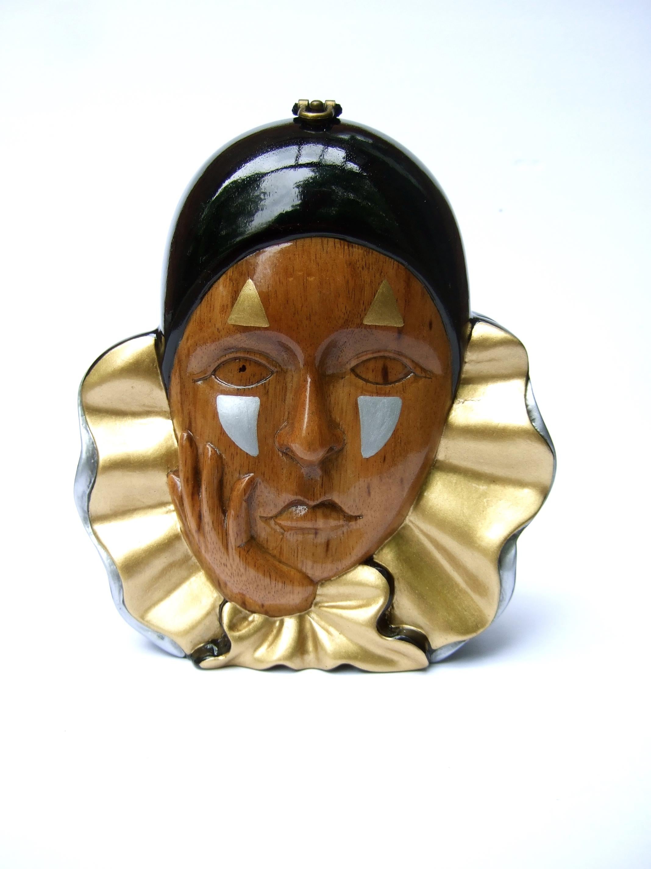 Timmy Woods Beverly Hills wood enamel artisan harlequin handbag 
The unique handmade wood handbag is designed with a harlequin 
sad clown figure

The hand carved harlequin is embellished with enamel features & accents
The versatile design can be