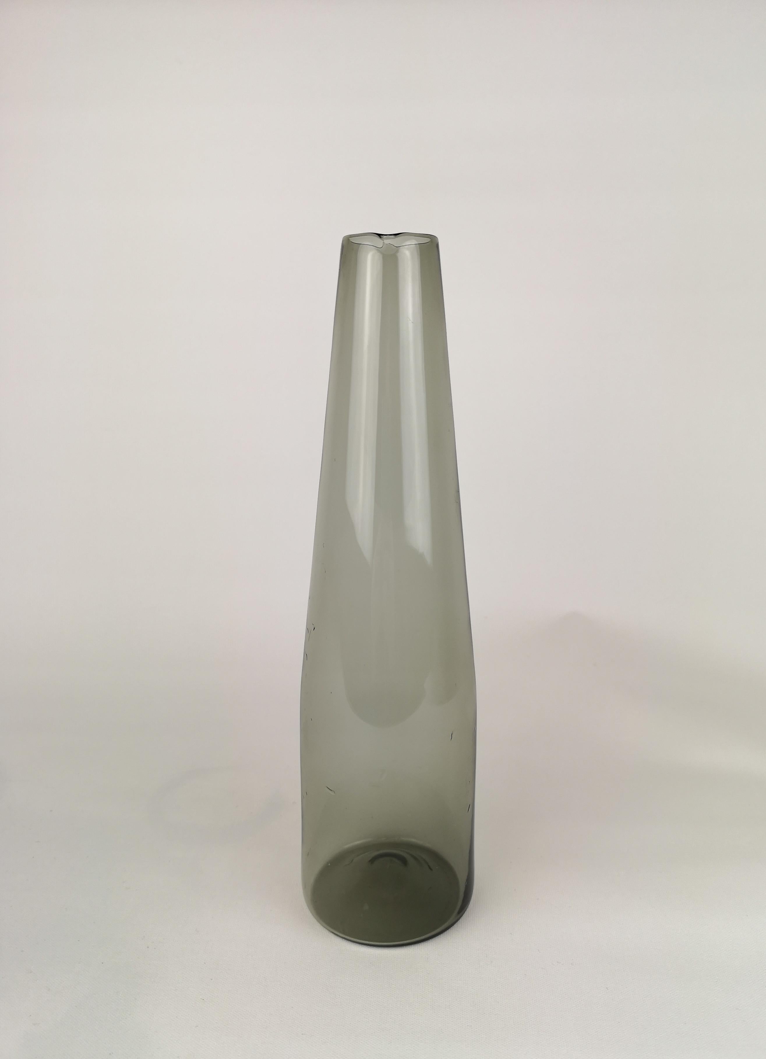 A very nice Carafe produced by Iittala in 1956-1962 and designed by Timo Sarpaneva. This one is in good condition. 

Fully signed in the bottom of the Carafe.
  