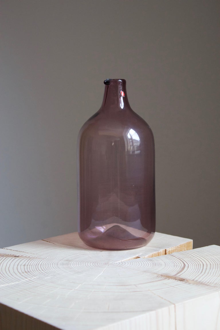 A hand blown organic vase or bottle, designed by Timo Sarpaneva for Ittala. Bears original label, signed at the bottom.

Other designers of the period include Tapio Wirkkala, Alvar Aalto, Paavo Tynell.