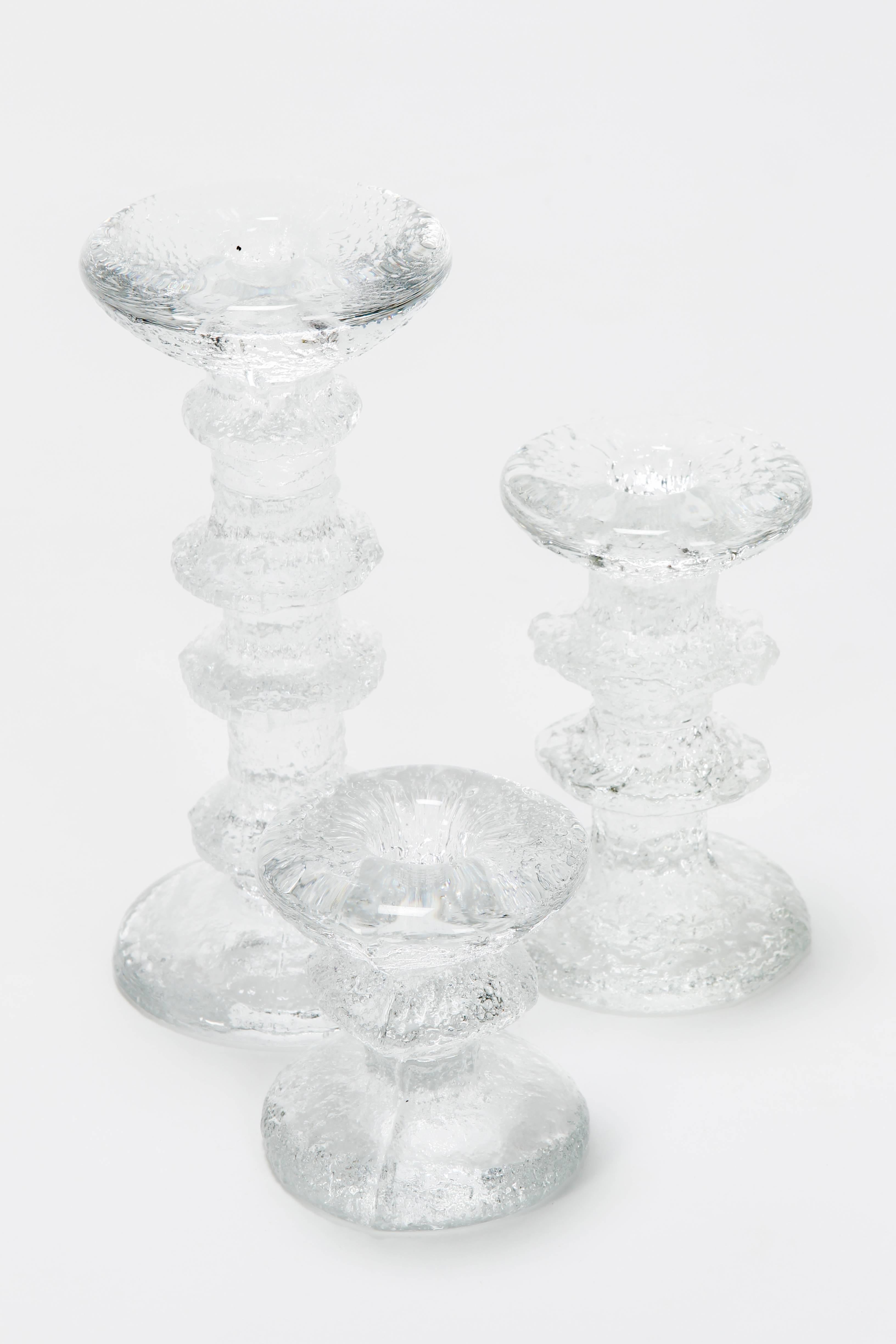 Timo Sarpaneva “Festivo” candle holders manufactured by Littala in the 1960s in Finland. Column shaped, textured glass candleholders. All are signed with the initials of the designer on the bottom.

Dimensions: Large
Diameter 8 cm
Height 17