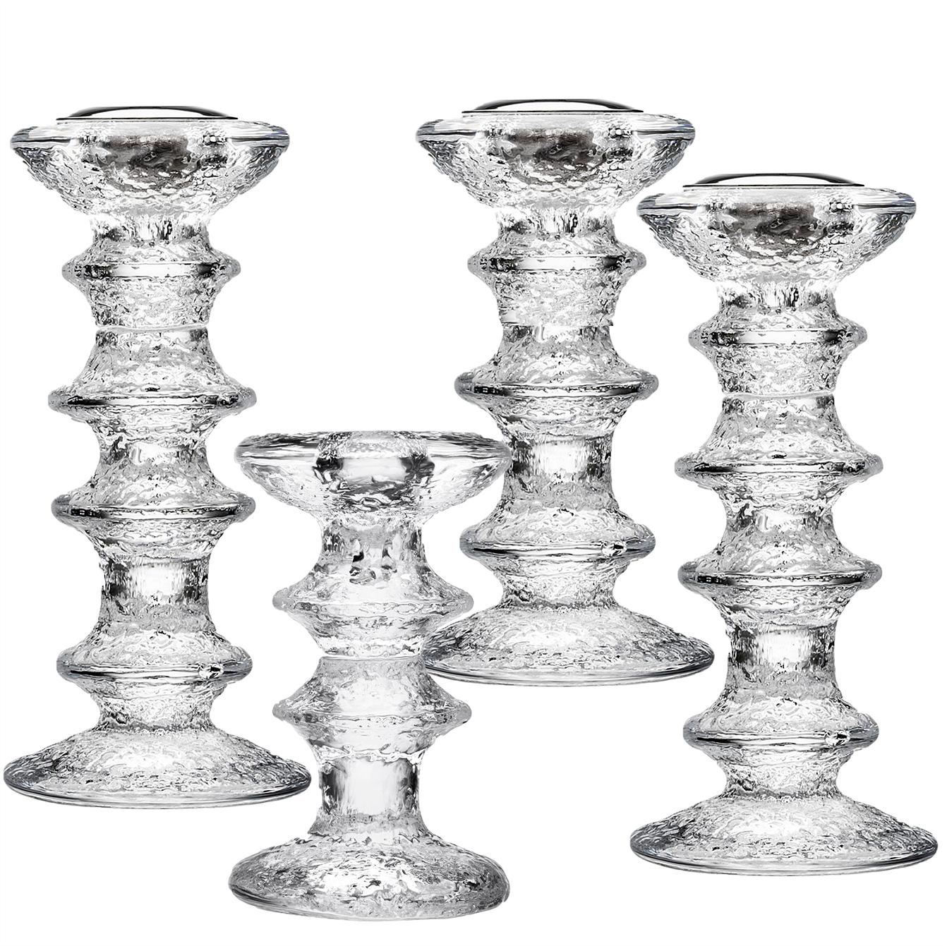 Textured clear molded glass. Composed as a column with projecting bands, a flared mouth and a round base. Designed by Sarpaneva for Liitala, Finland.

The tallest, four-ring candleholder is 7.25 in. H, the three-ring design is 5.75 in. H, and the